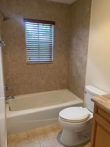 a bathroom with a toilet and a bath tub