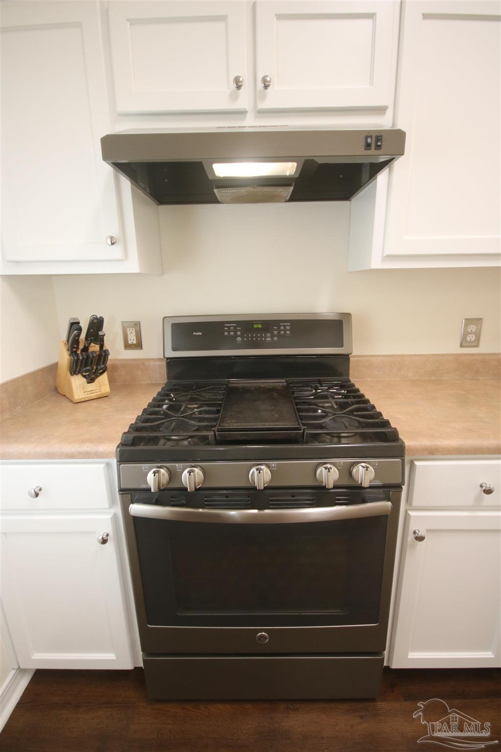 4930 Chads Circle Milton, FL 32571 - Photo 14 of 50 a stove top oven sitting inside of a kitchen