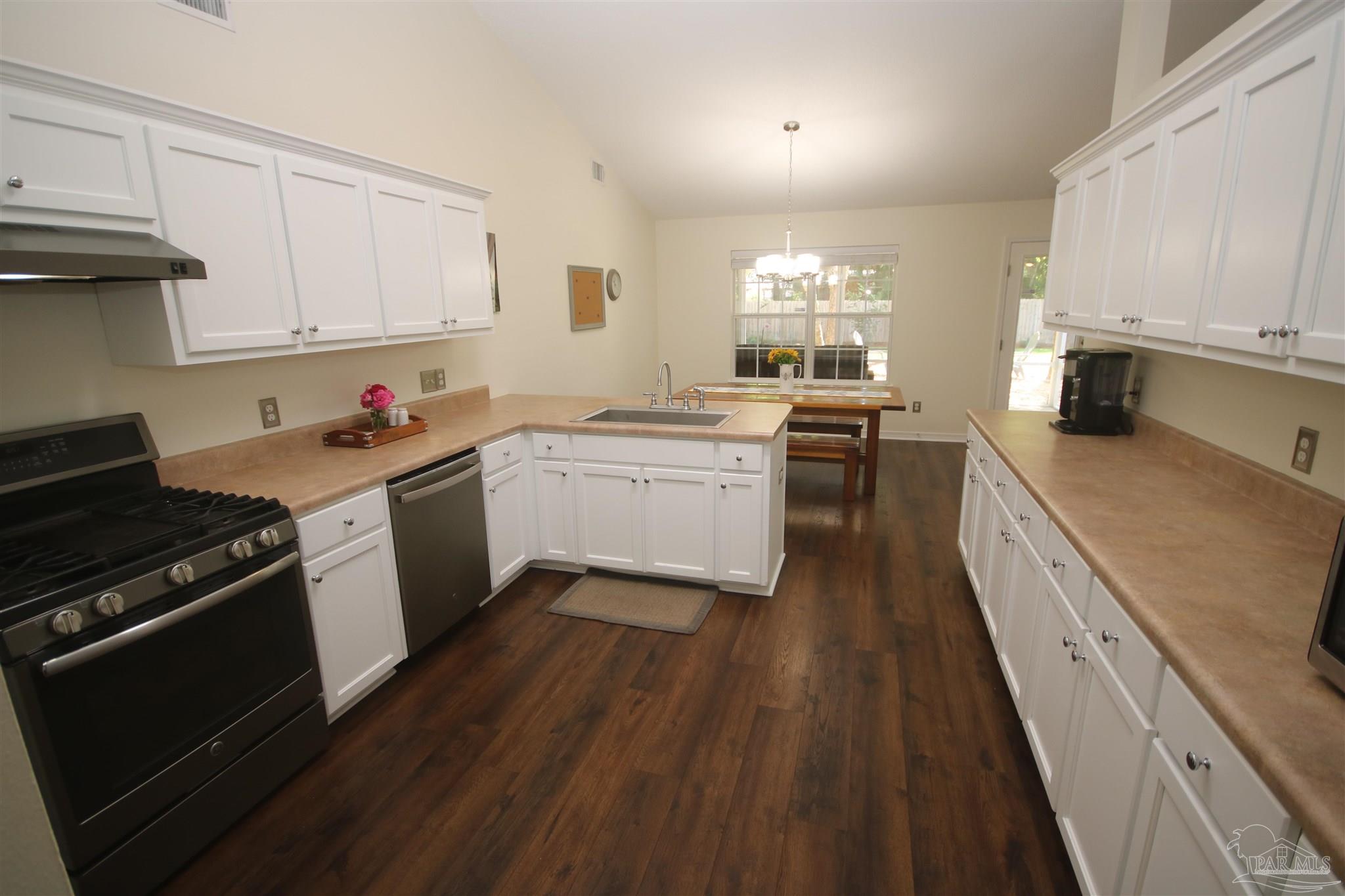 4930 Chads Circle Milton, FL 32571 - Photo 17 of 50 a kitchen with a sink a stove and cabinets