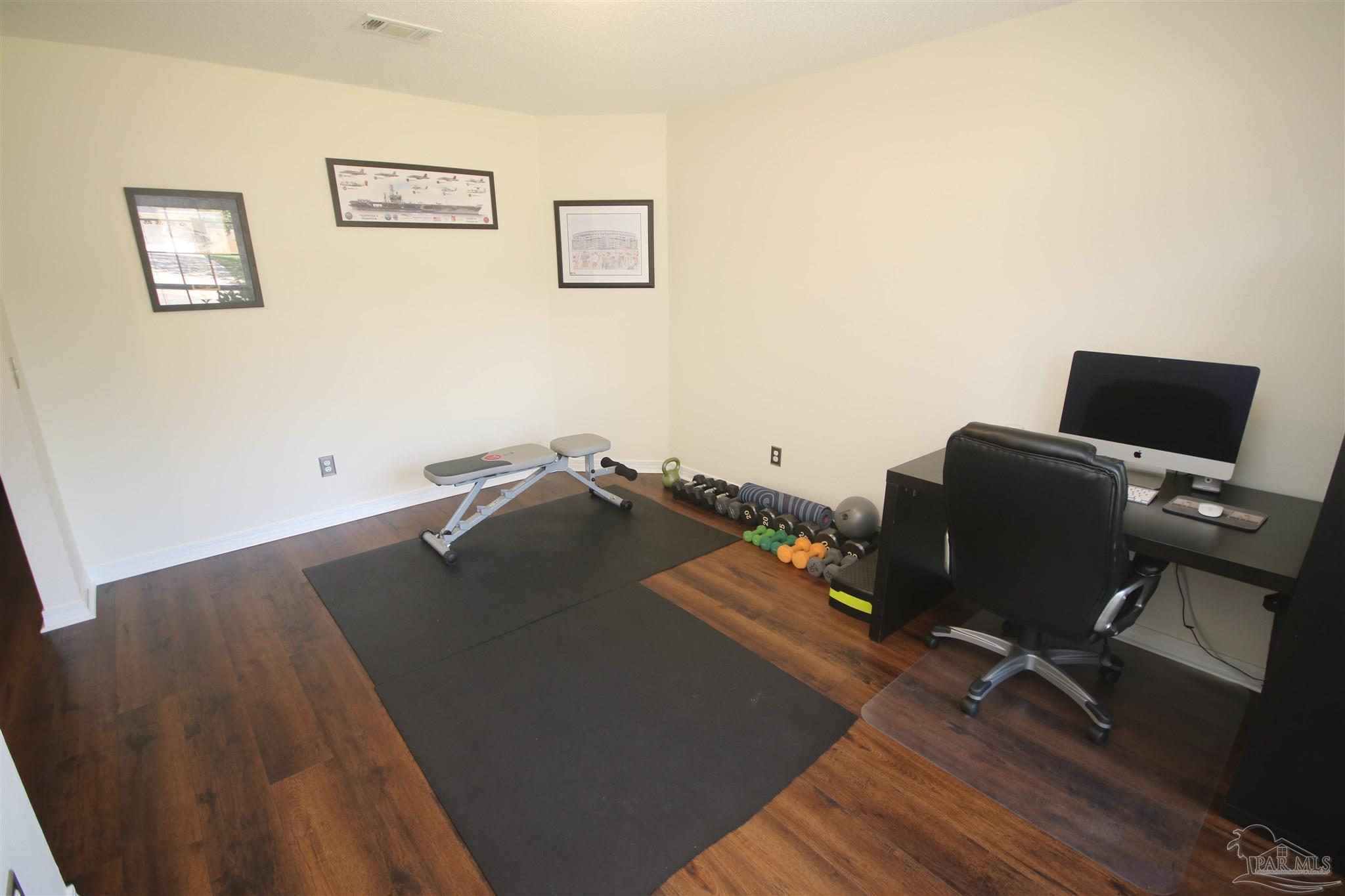 4930 Chads Circle Milton, FL 32571 - Photo 21 of 50 a bed sitting in a living room next to a window