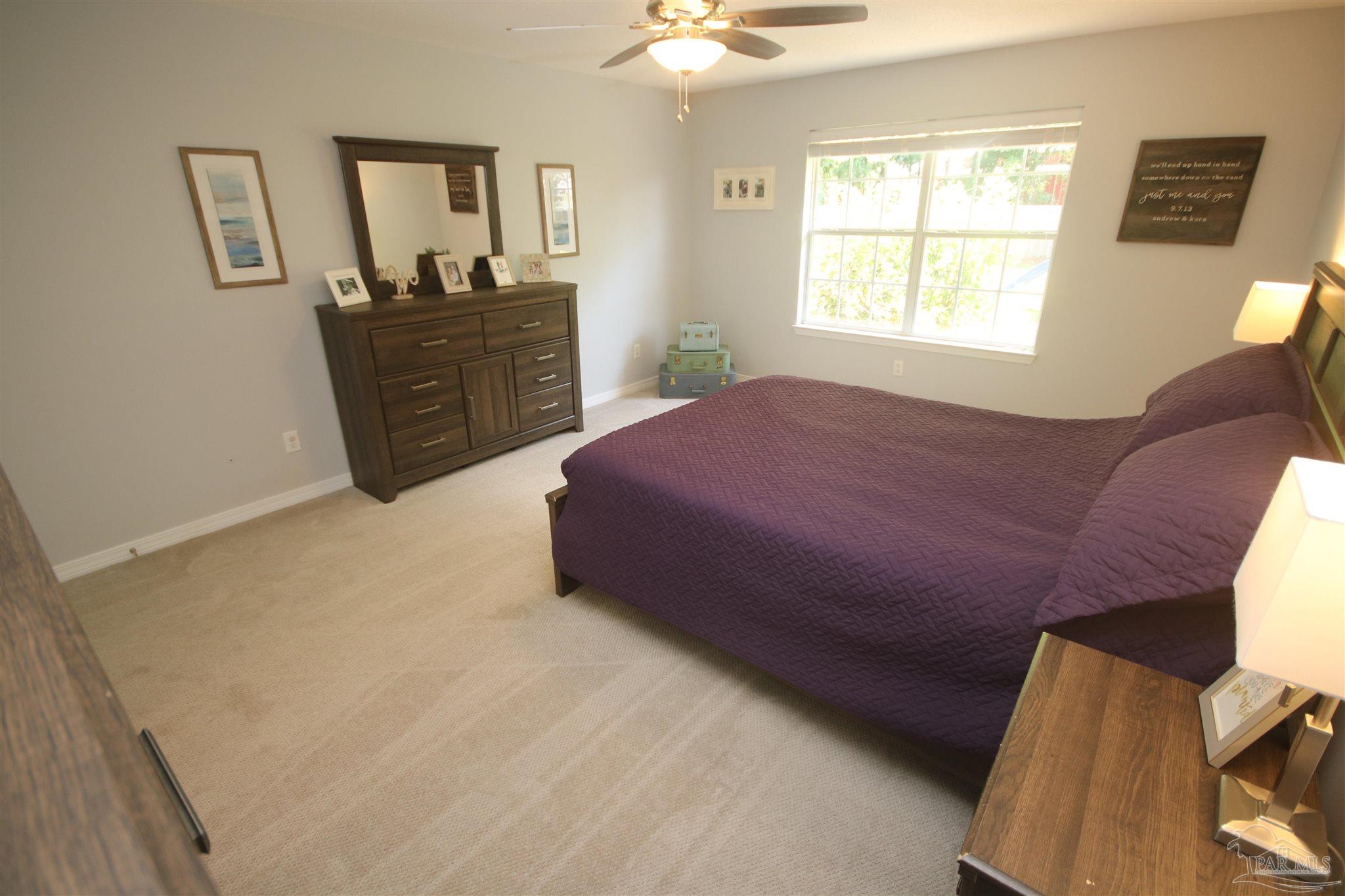 4930 Chads Circle Milton, FL 32571 - Photo 28 of 50 a spacious bedroom with a bed and a dresser