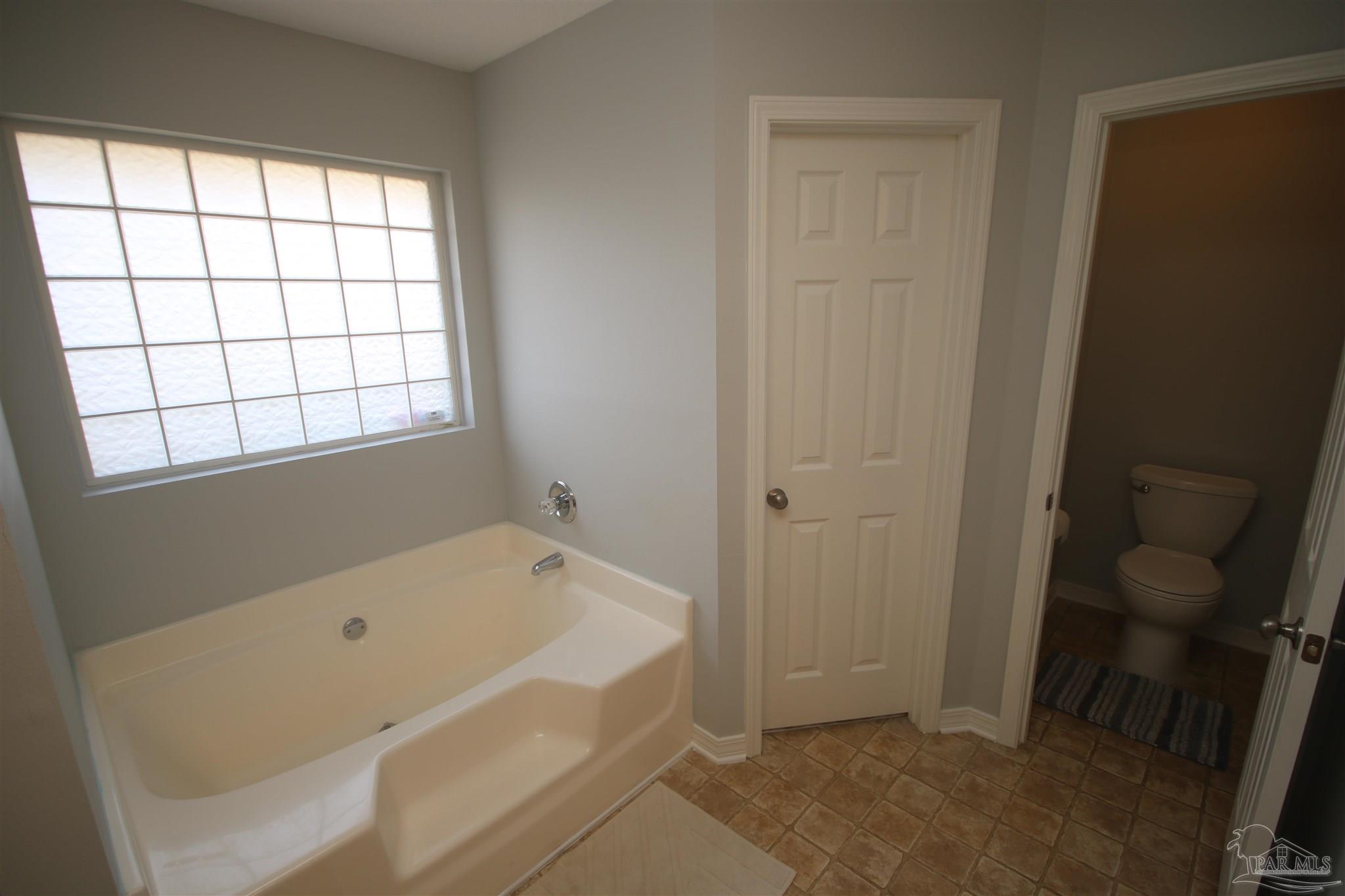 4930 Chads Circle Milton, FL 32571 - Photo 30 of 50 a bathroom with a tub and shower