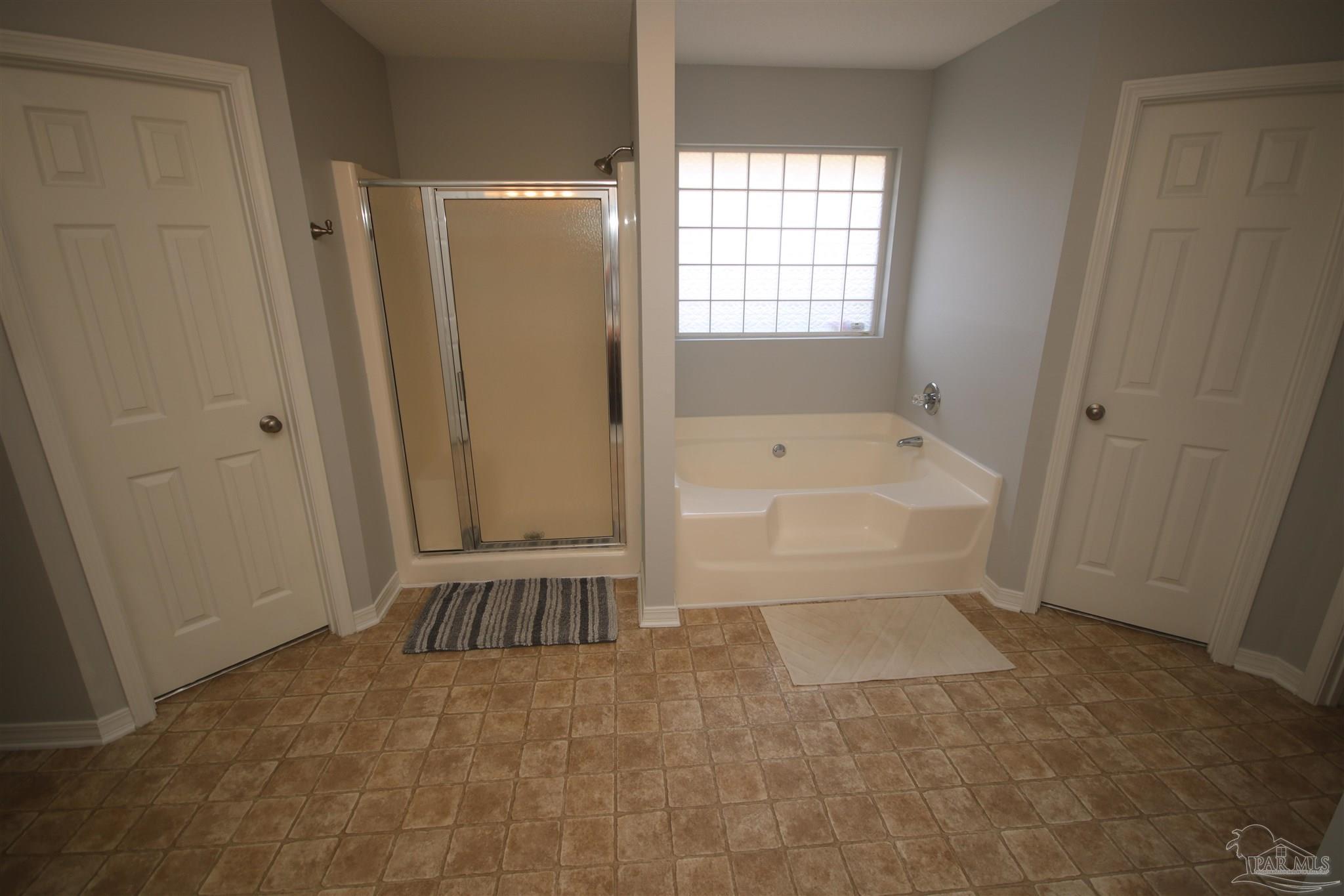 4930 Chads Circle Milton, FL 32571 - Photo 32 of 50 a bathroom with a tub shower and a sink