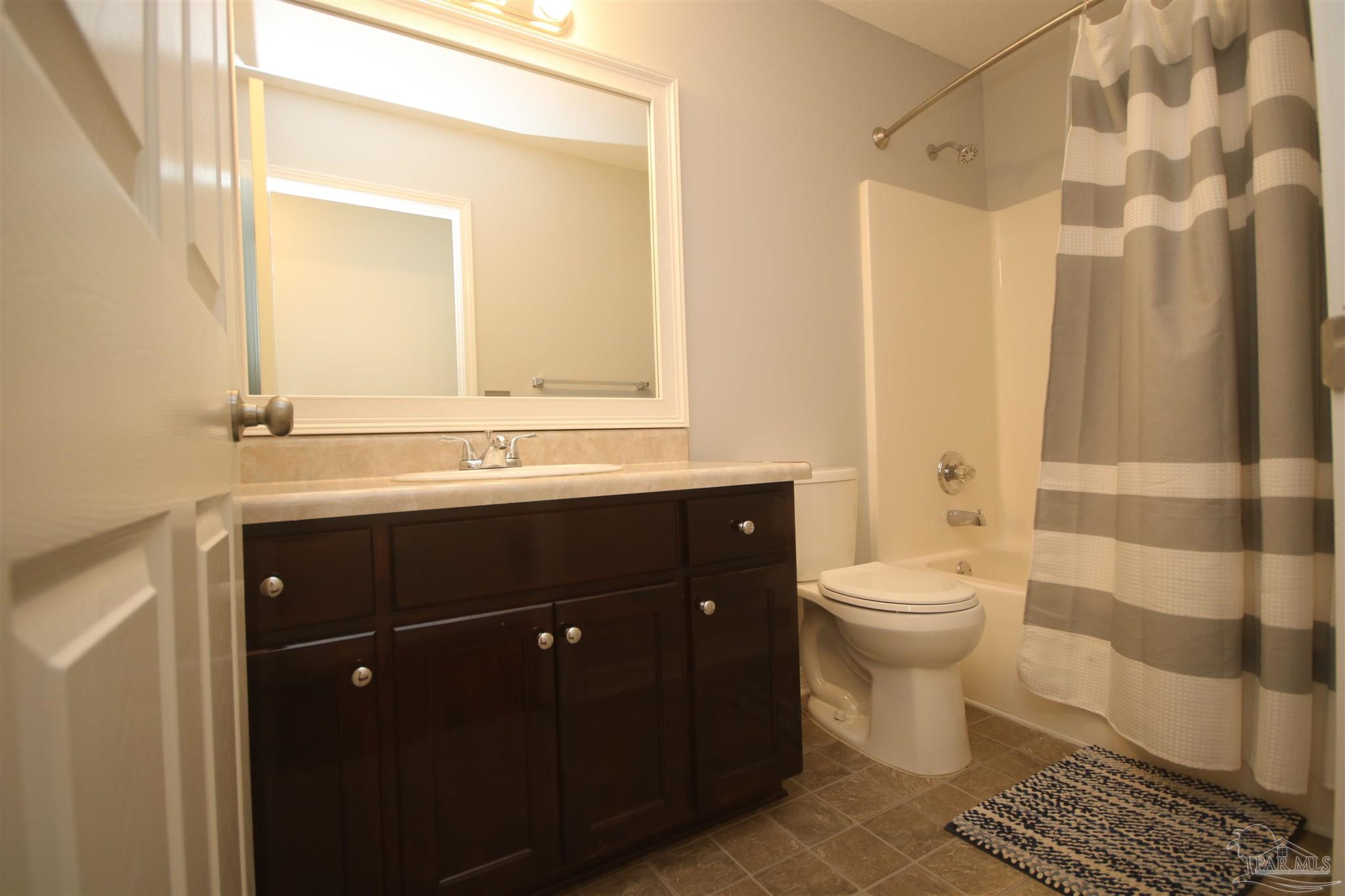 4930 Chads Circle Milton, FL 32571 - Photo 37 of 50 a bathroom with a sink a toilet and shower