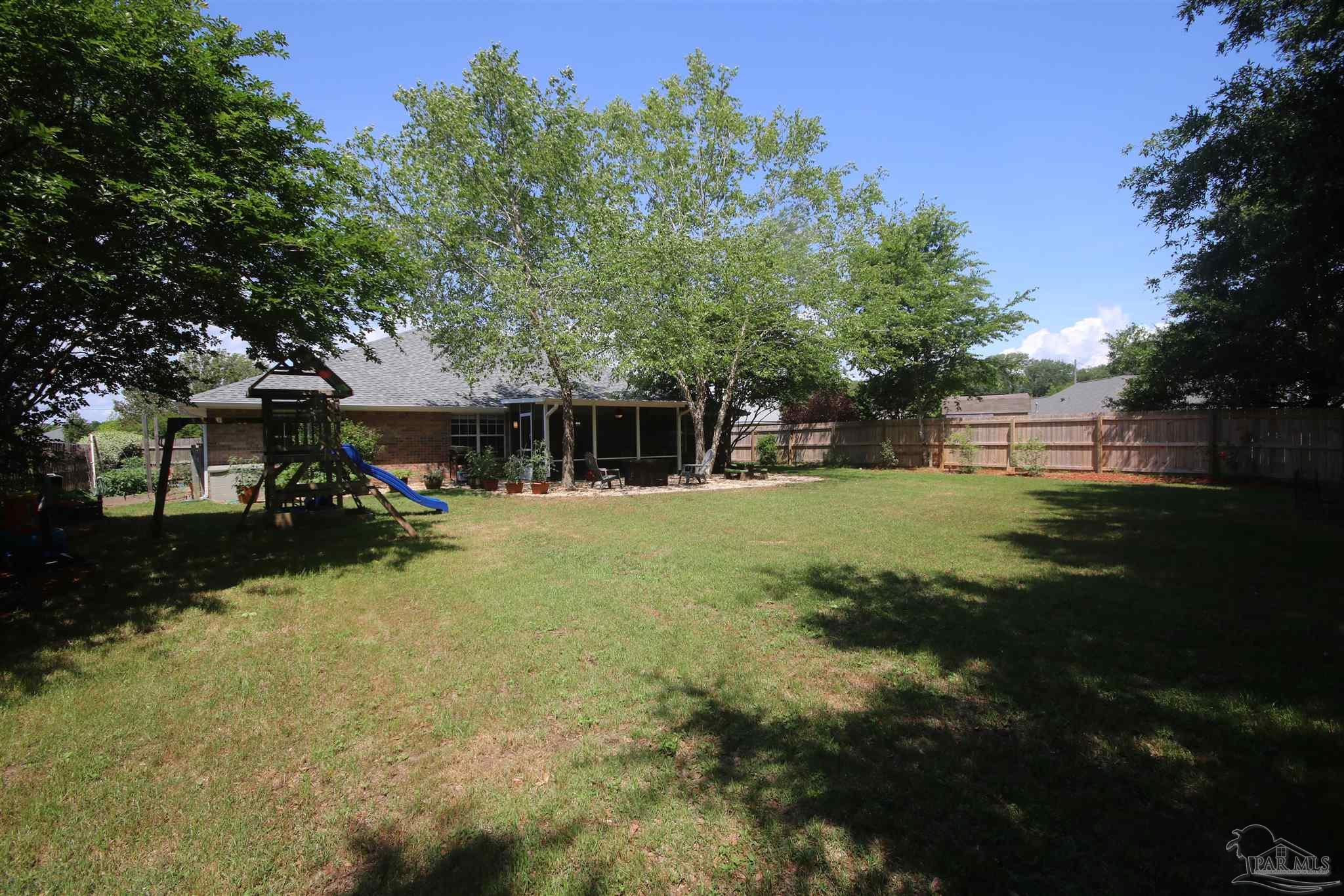 4930 Chads Circle Milton, FL 32571 - Photo 4 of 50 a front view of a house with a yard