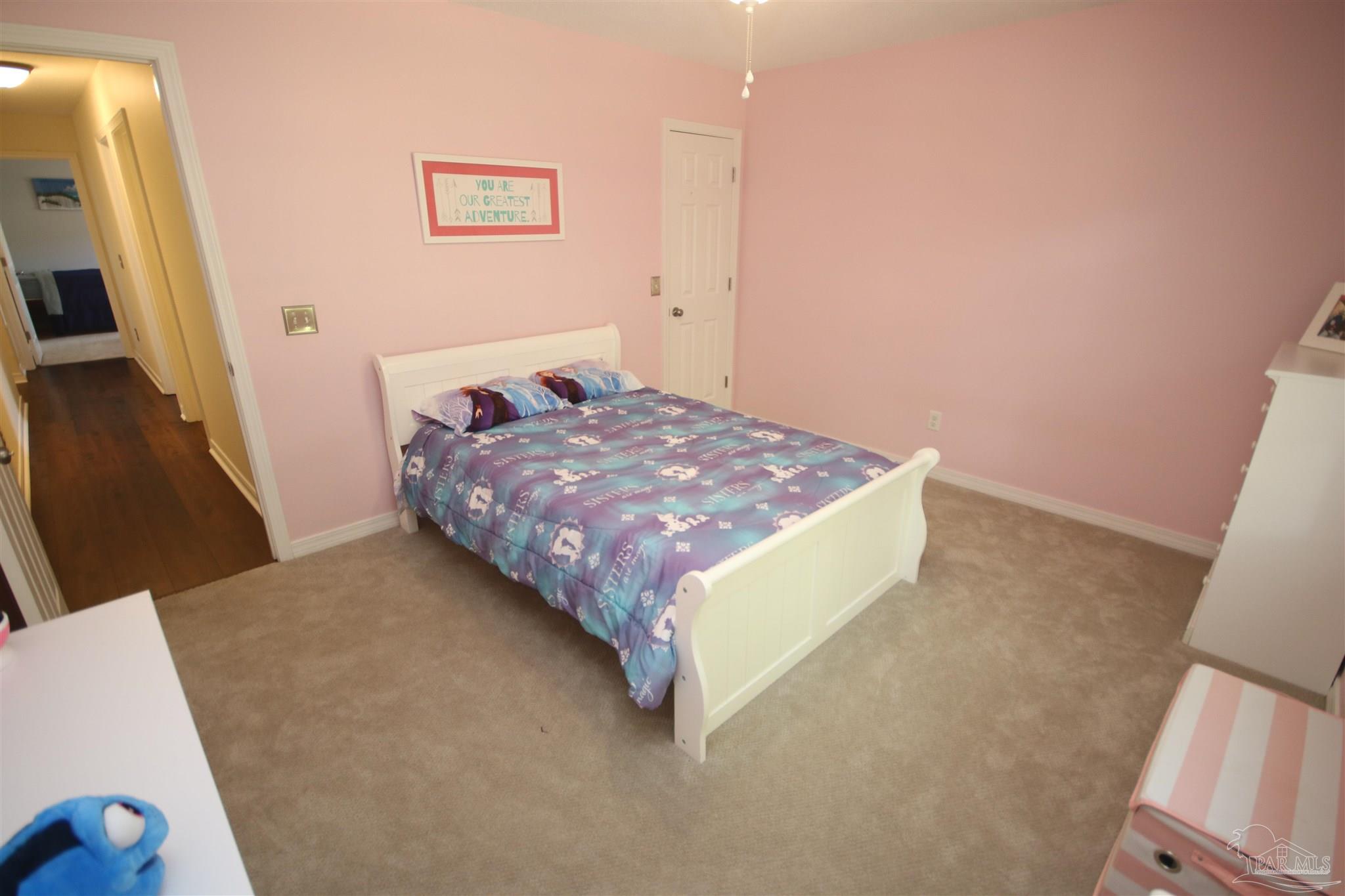 4930 Chads Circle Milton, FL 32571 - Photo 41 of 50 a bed sitting in a bedroom next to a window