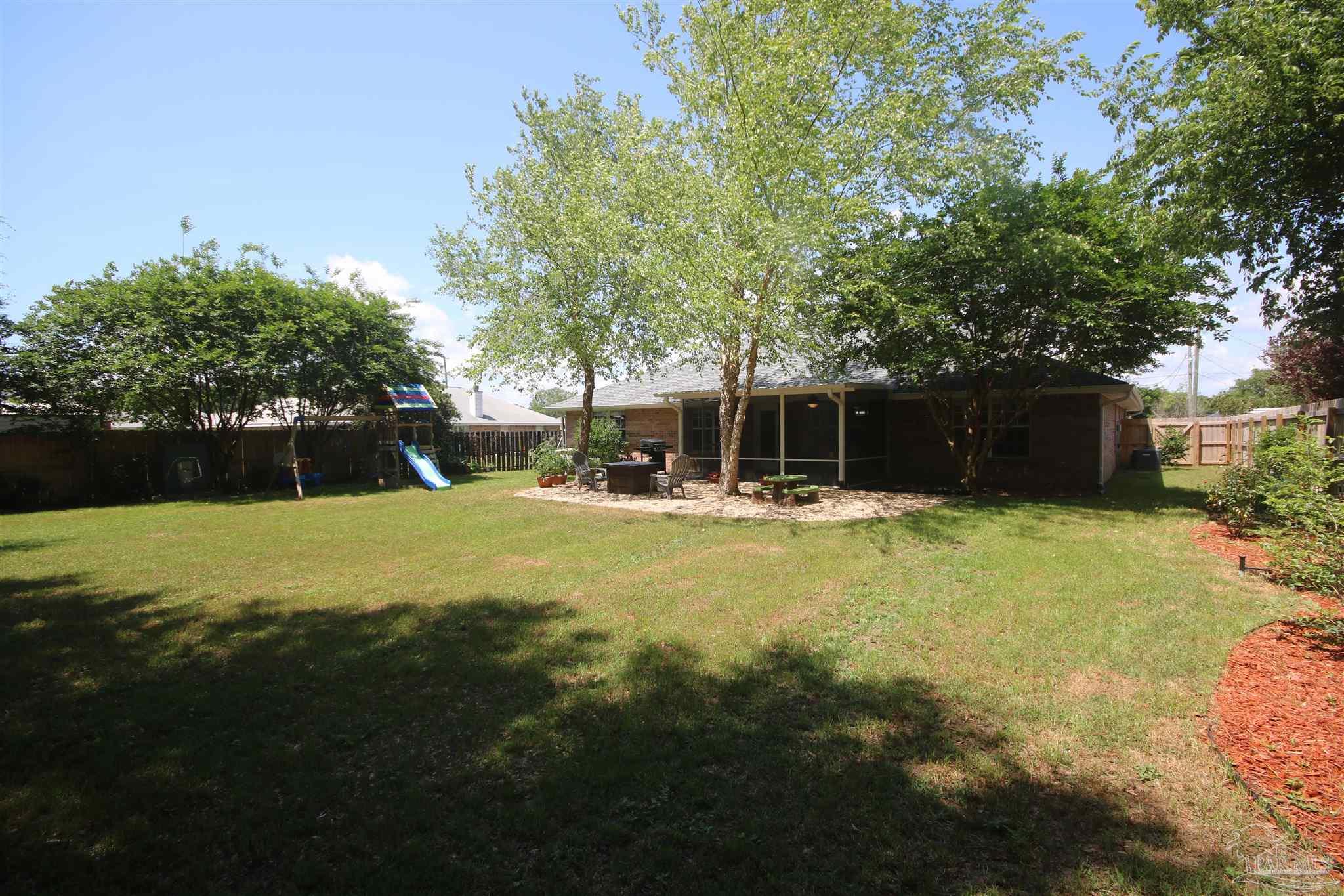 4930 Chads Circle Milton, FL 32571 - Photo 46 of 50 a swimming pool with outdoor seating and yard