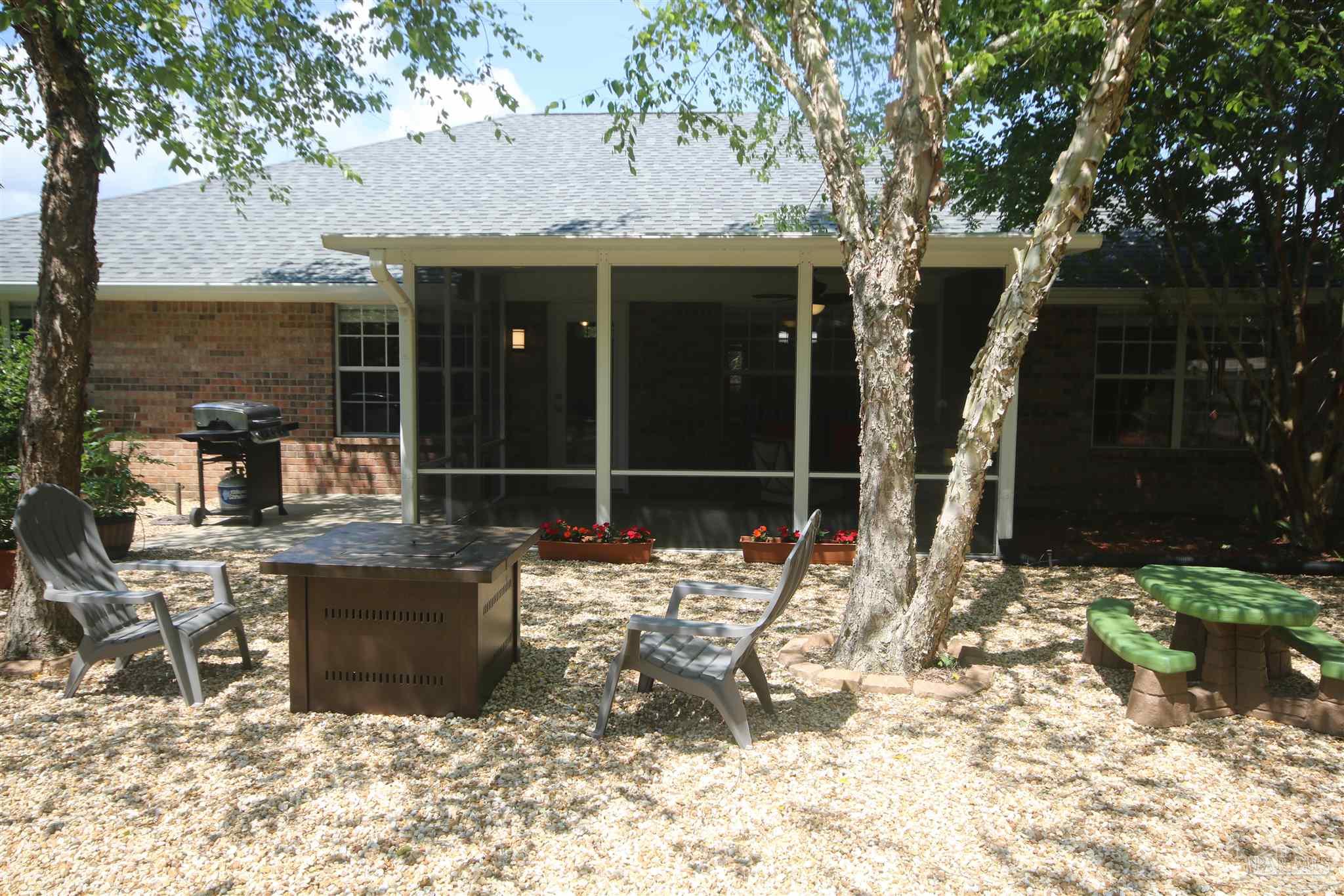 4930 Chads Circle Milton, FL 32571 - Photo 48 of 50 a view of an chairs and tables in the patio