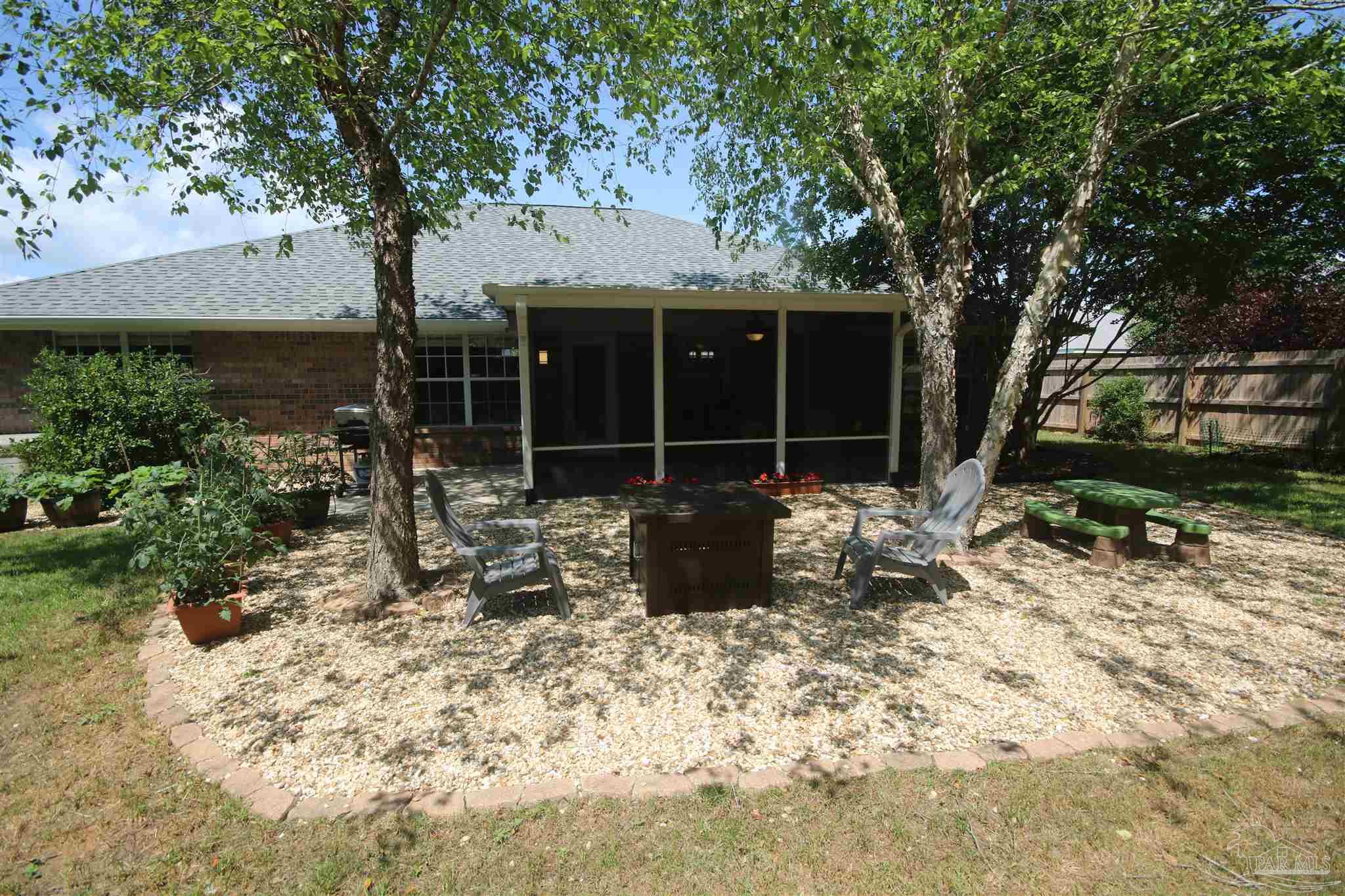 4930 Chads Circle Milton, FL 32571 - Photo 49 of 50 a view of a backyard with sitting area and furniture