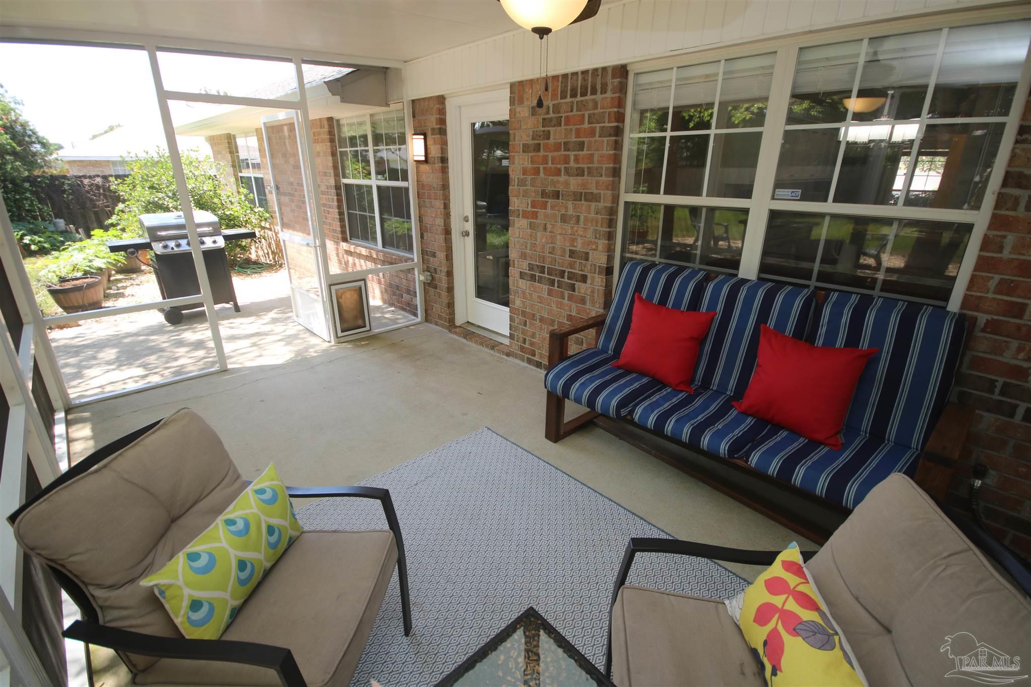 4930 Chads Circle Milton, FL 32571 - Photo 5 of 50 a living room with furniture and a floor to ceiling window
