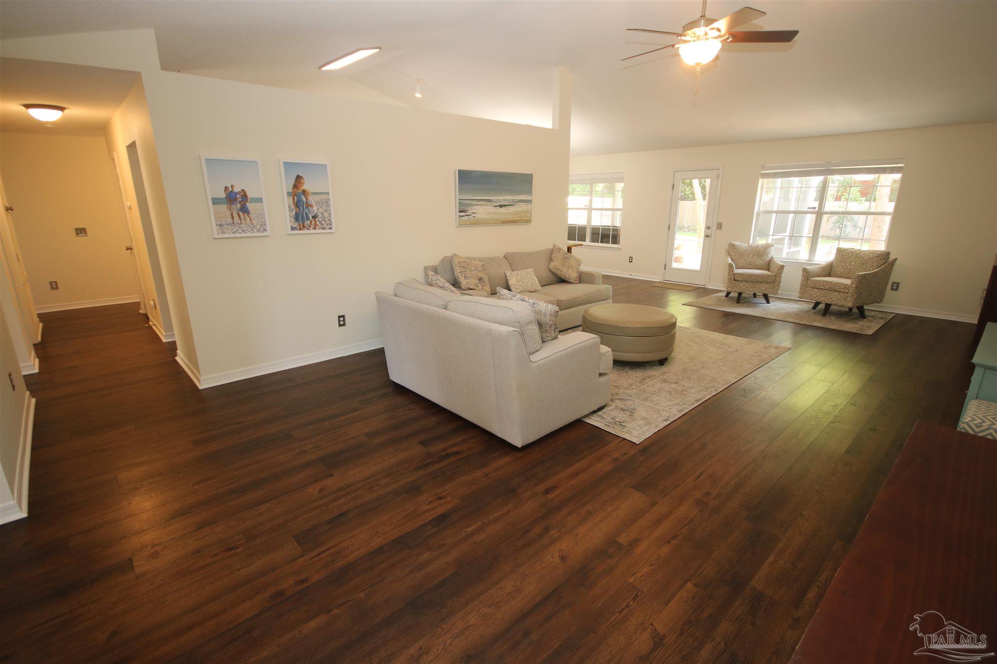 4930 Chads Circle Milton, FL 32571 - Photo 7 of 50 a living room with furniture and a wooden floor