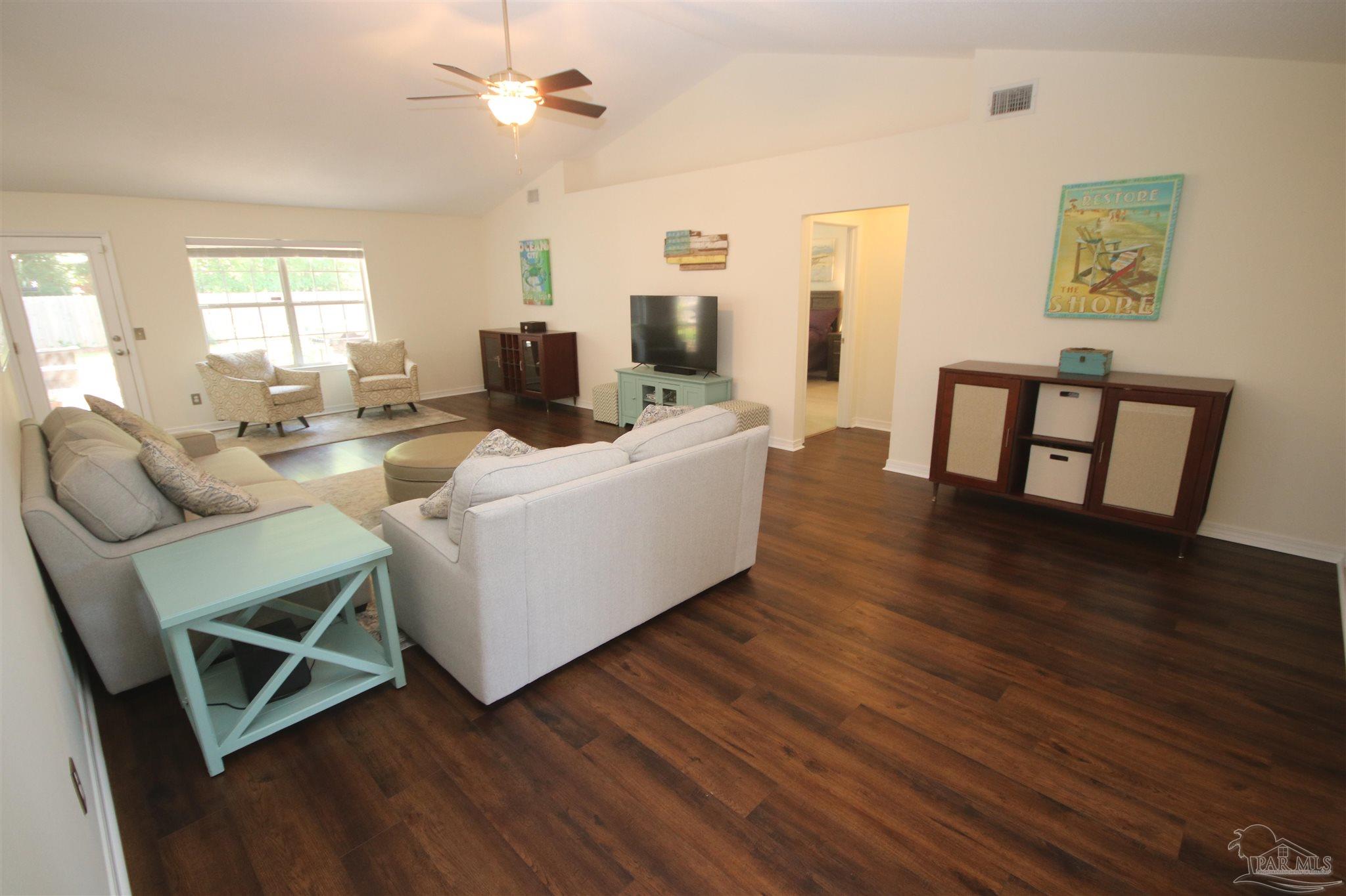 4930 Chads Circle Milton, FL 32571 - Photo 8 of 50 a living room with fireplace furniture and a wooden floor