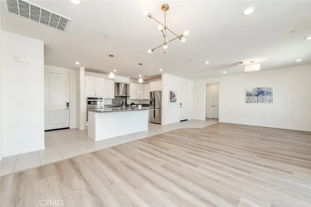 a view of kitchen with refrigerator stove microwave and cabinets