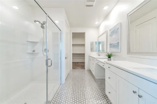 a spacious bathroom with a sink and a mirror