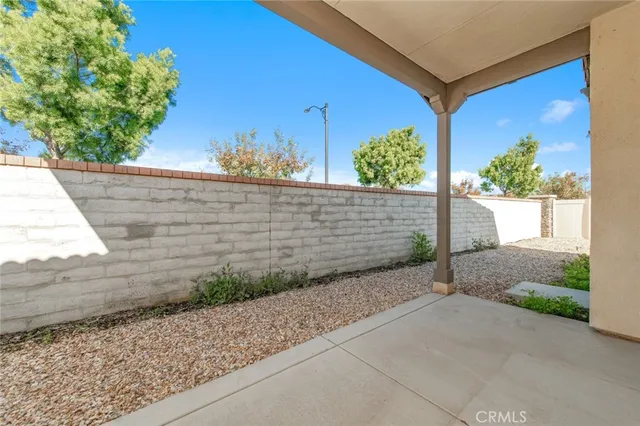 a view of a garden with a bench in patio