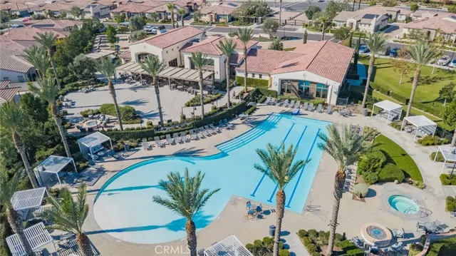 a view of swimming pool with outdoor seating and plants