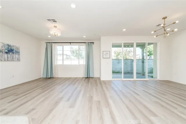 a view of wooden floor and windows in a room