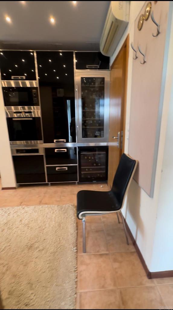 2 Flowers, Unit 51 Absecon, NJ 08205 - Photo 29 of 37 a hallway with wine table and chairs