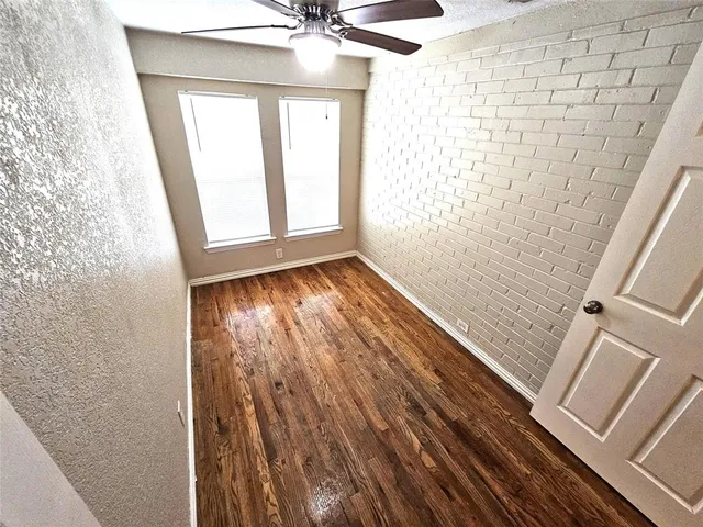 a view of an empty room and wooden floor