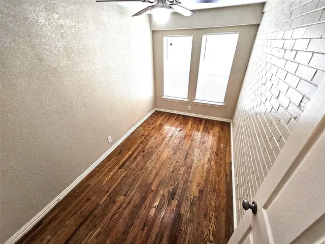 a view of an empty room and wooden floor