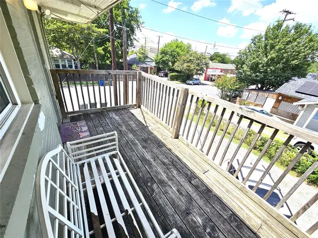 a view of a balcony with wooden floor