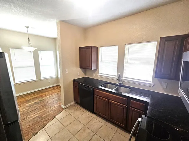 a kitchen with a sink appliances and a window