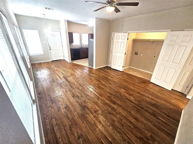 a view of an empty room and wooden floor