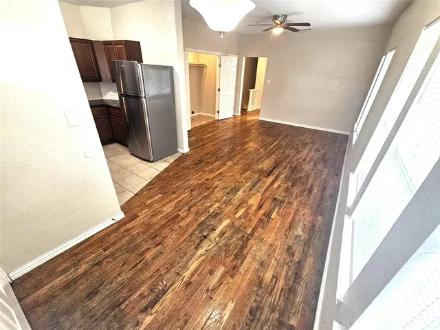 a view of a refrigerator in kitchen and wooden floor