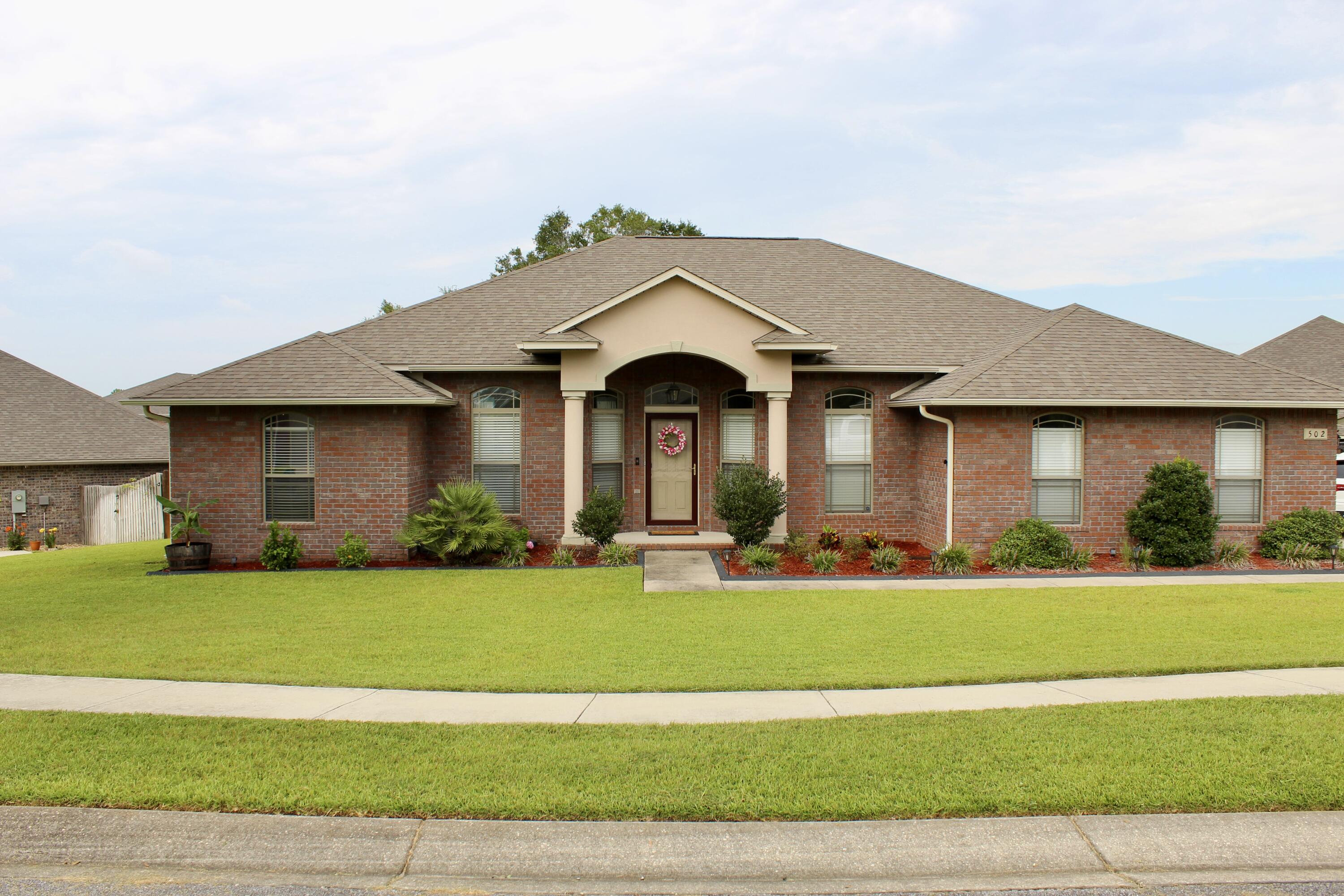 502 Vale Loop Crestview, FL 32536 - Photo 1 of 53 a front view of a house with a yard and garage