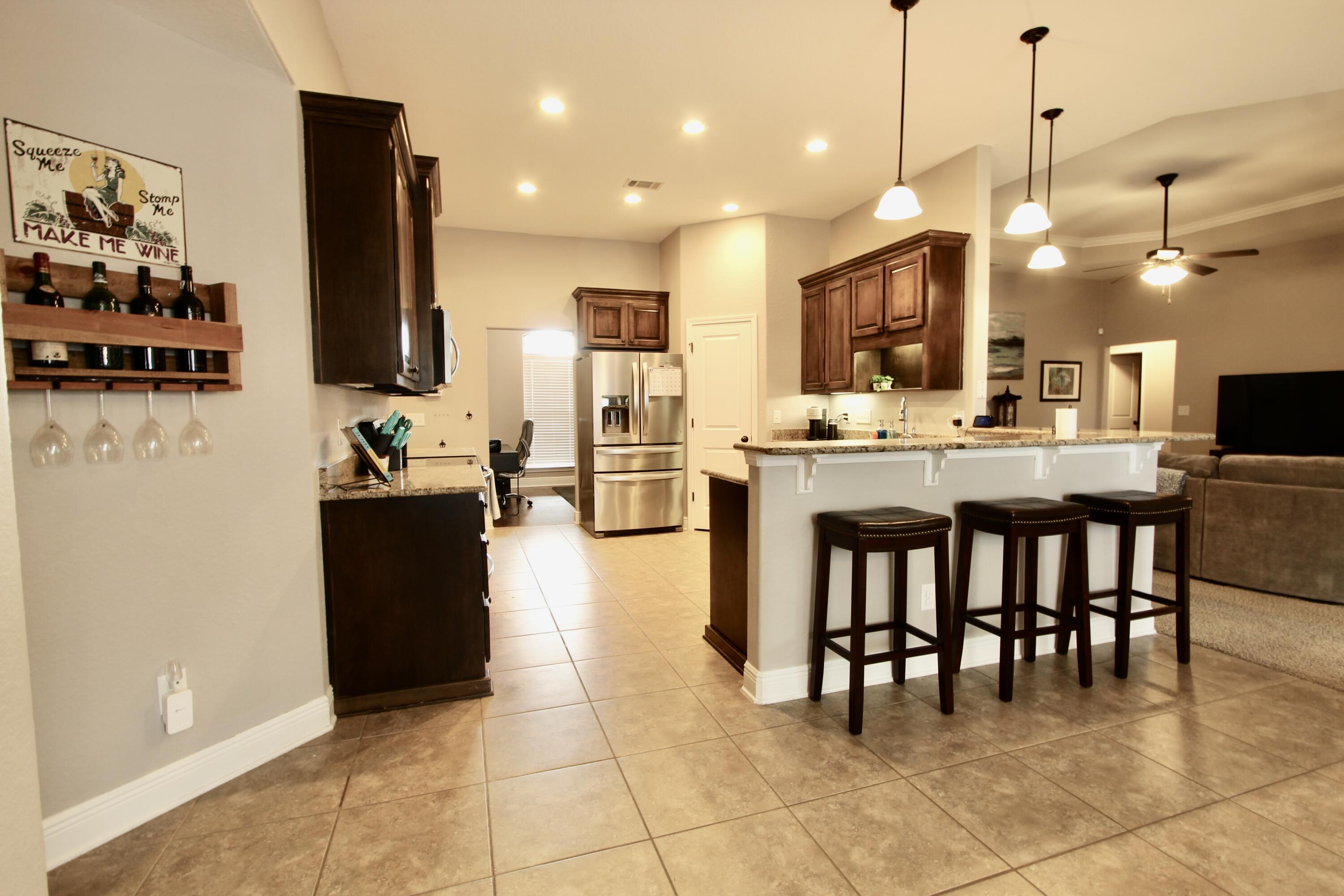 502 Vale Loop Crestview, FL 32536 - Photo 13 of 53 a large kitchen with kitchen island a table and chairs