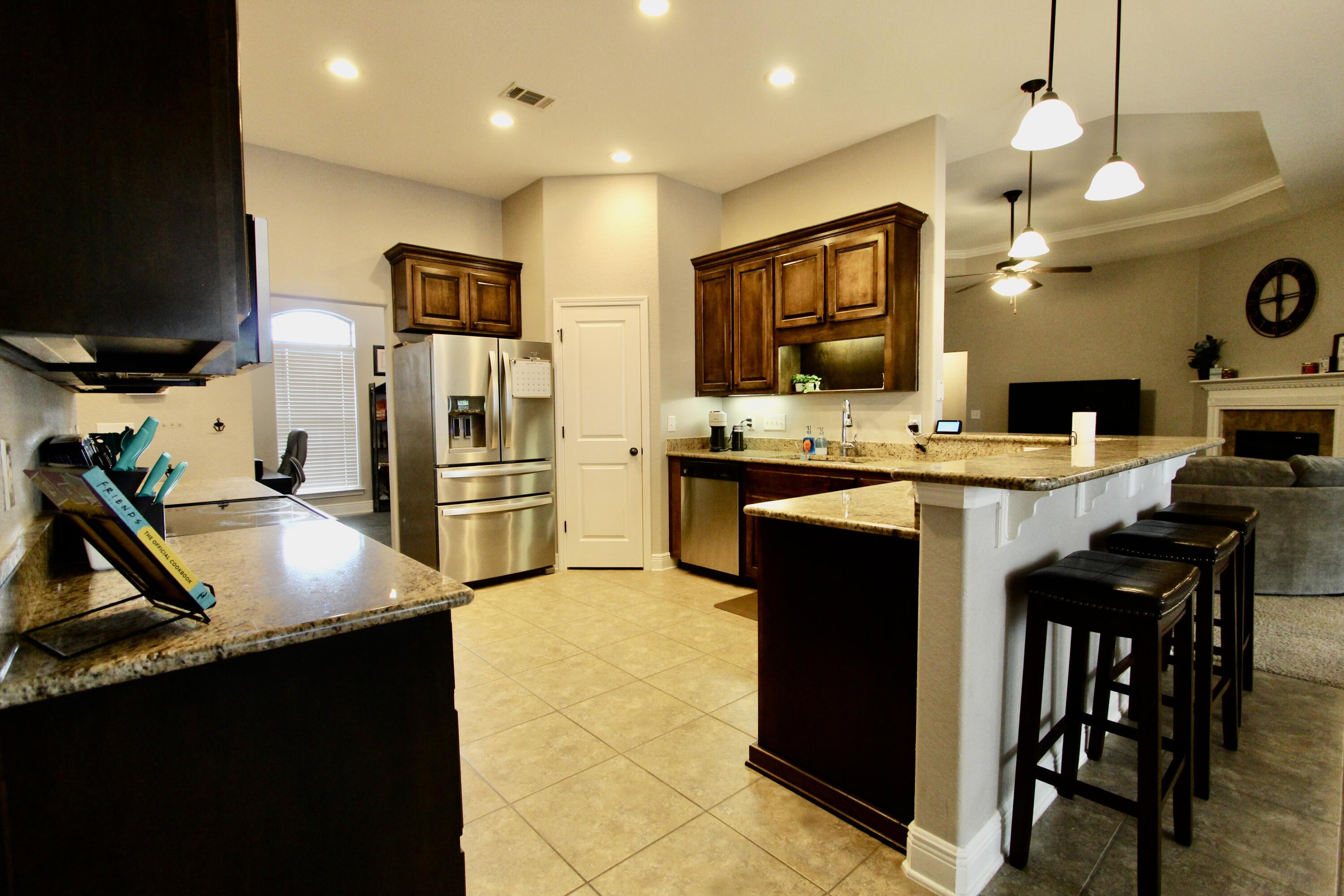 502 Vale Loop Crestview, FL 32536 - Photo 15 of 53 a kitchen with stainless steel appliances granite countertop a sink a stove and a refrigerator