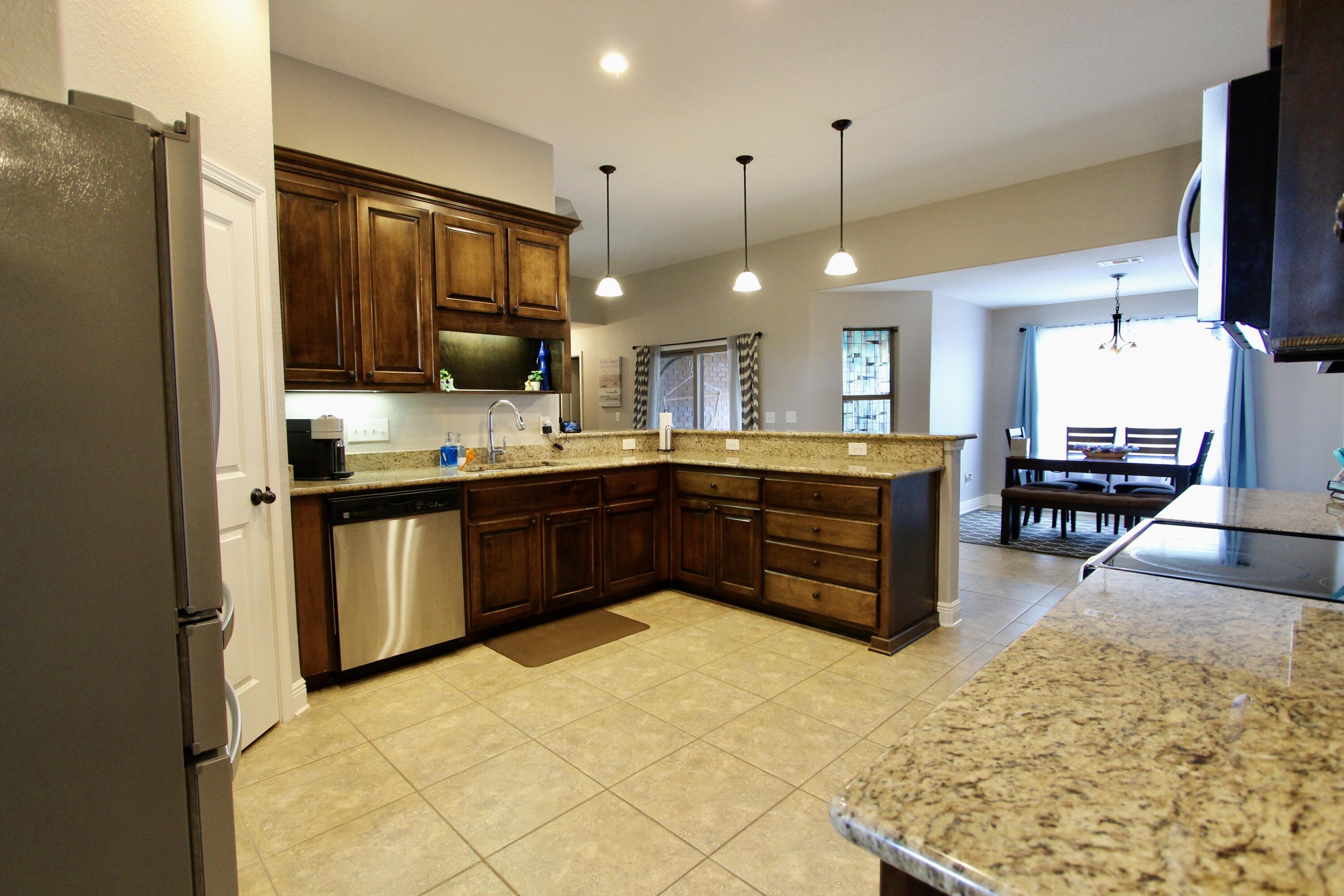 502 Vale Loop Crestview, FL 32536 - Photo 17 of 53 a kitchen with stainless steel appliances granite countertop a stove a sink and a refrigerator