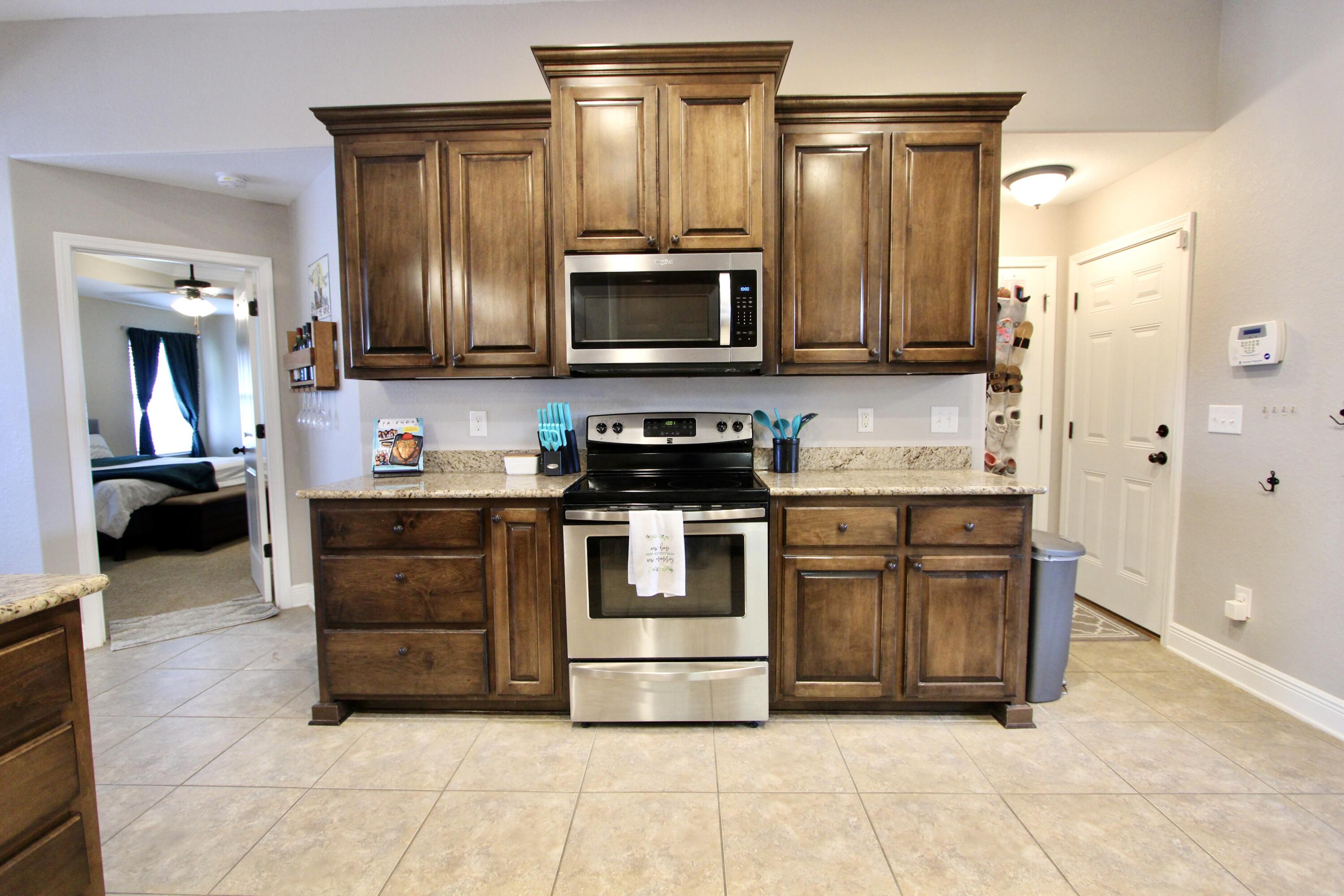 502 Vale Loop Crestview, FL 32536 - Photo 19 of 53 a kitchen with stainless steel appliances granite countertop a stove and a refrigerator