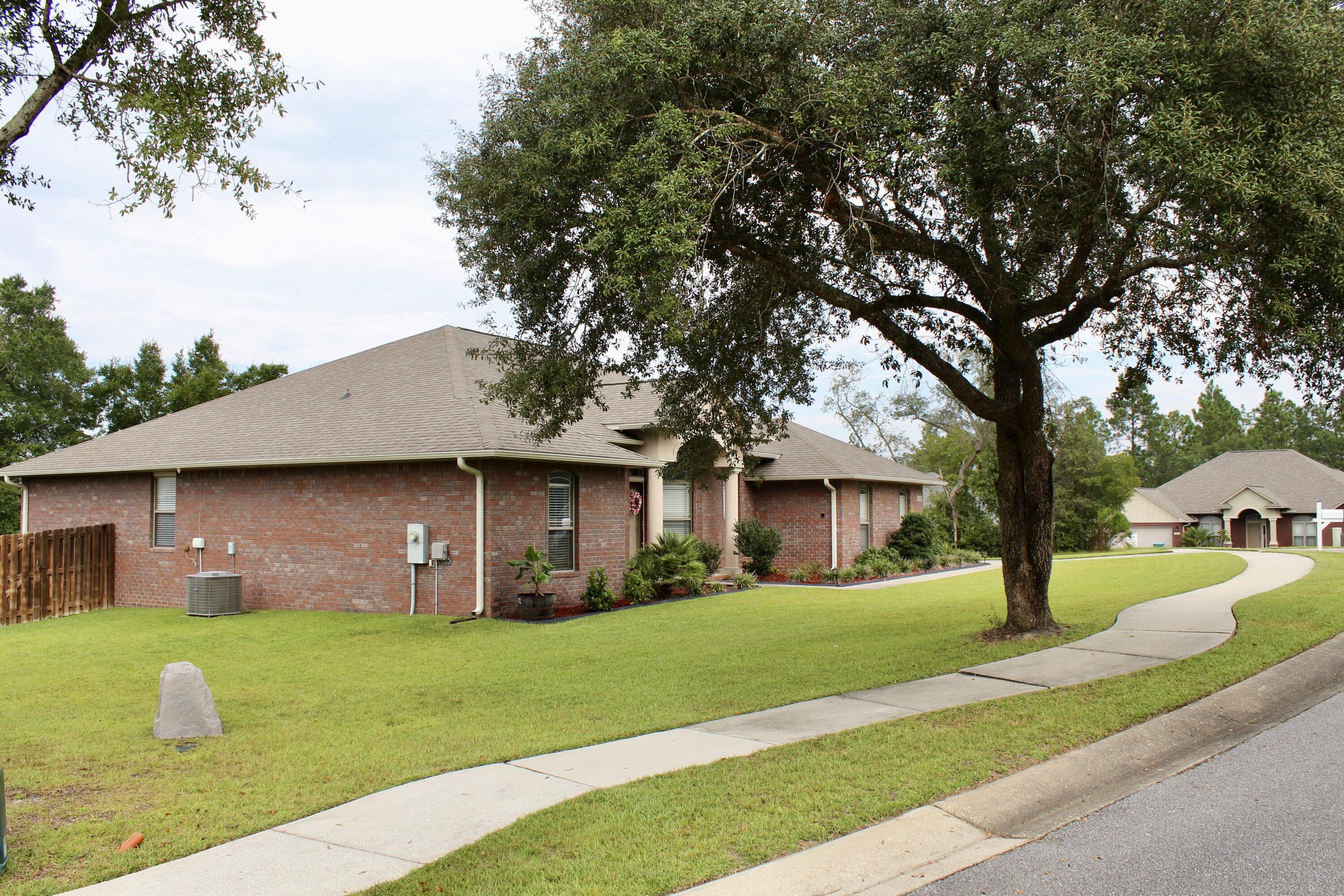 502 Vale Loop Crestview, FL 32536 - Photo 2 of 53 a front view of a house with garden