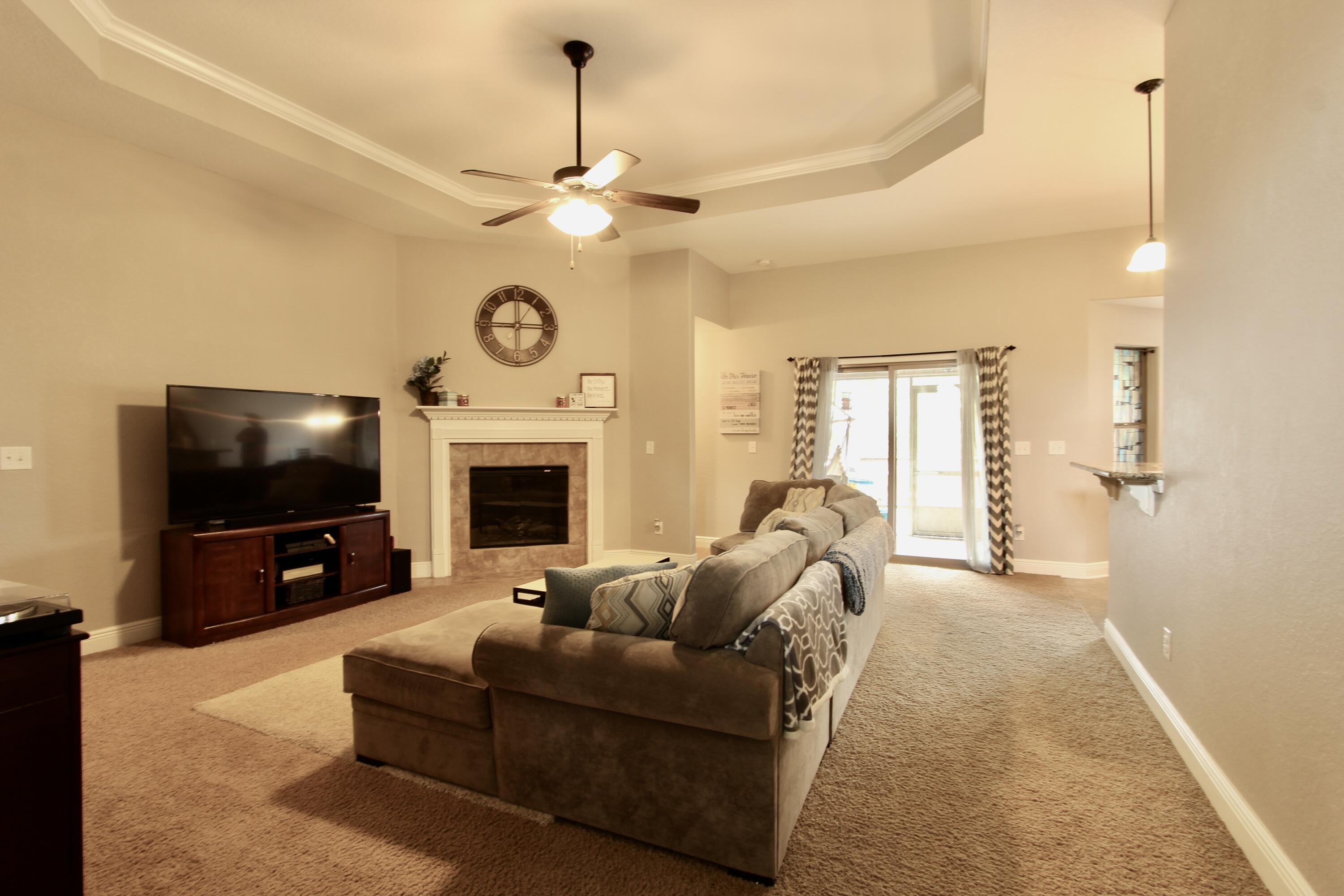 502 Vale Loop Crestview, FL 32536 - Photo 24 of 53 a living room with furniture a flat screen tv and a fireplace