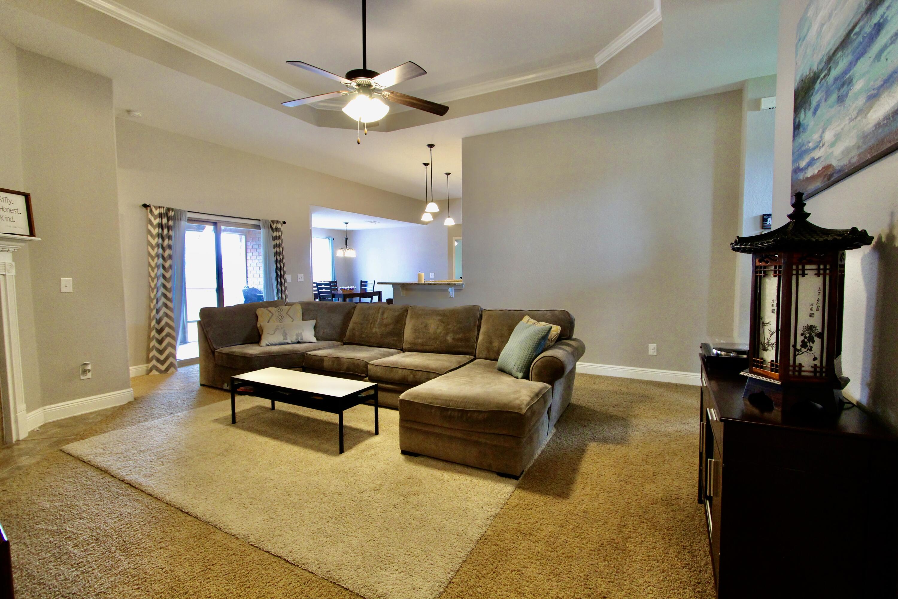 502 Vale Loop Crestview, FL 32536 - Photo 25 of 53 a living room with furniture a ceiling fan and a rug