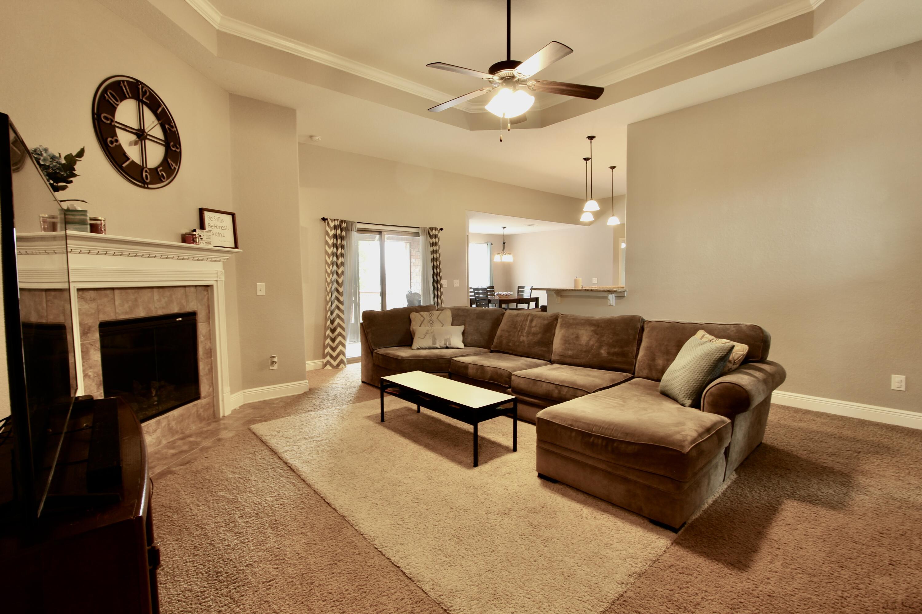 502 Vale Loop Crestview, FL 32536 - Photo 26 of 53 a living room with furniture a fireplace and a chandelier