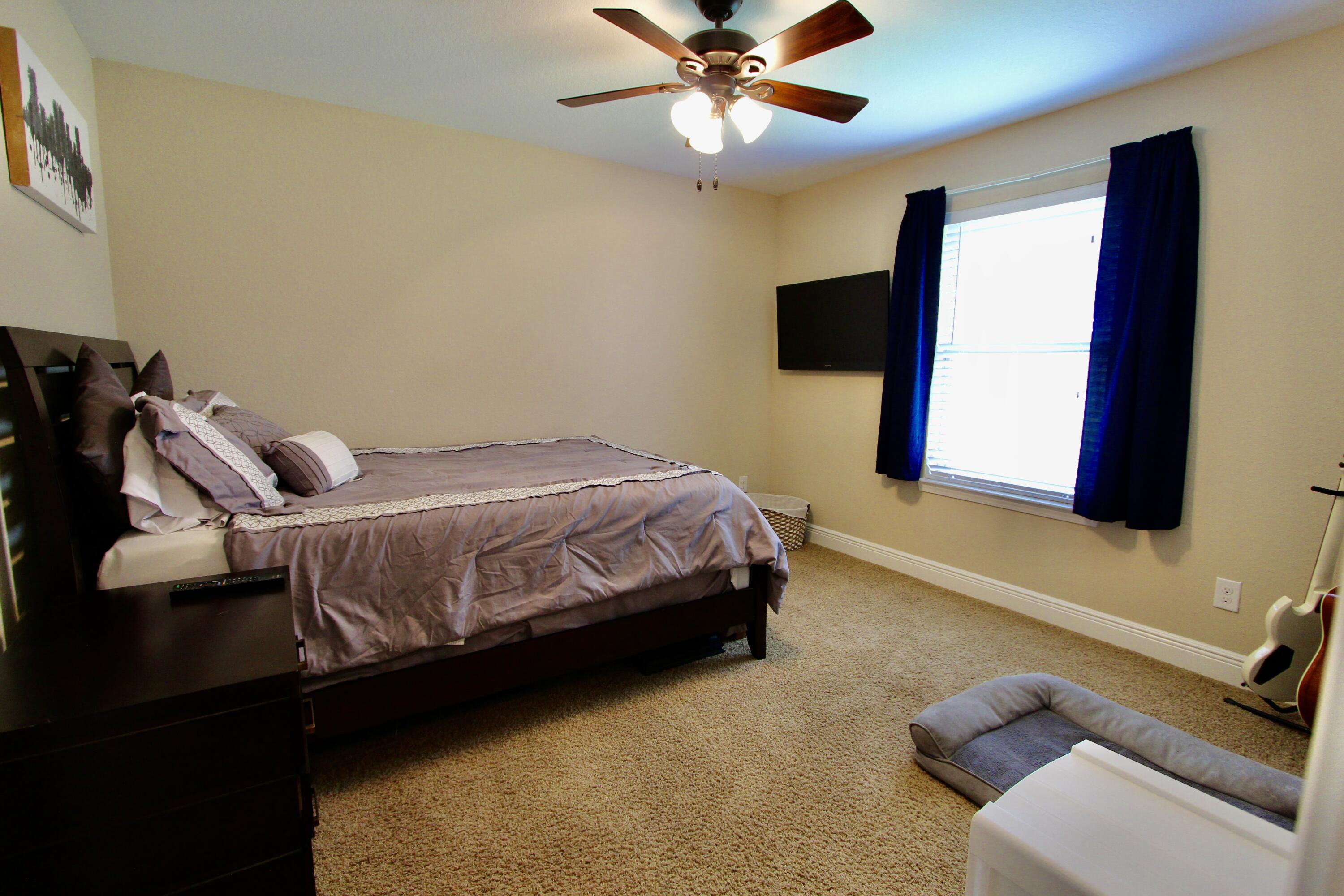 502 Vale Loop Crestview, FL 32536 - Photo 32 of 53 a bedroom with a bed and ceiling fan
