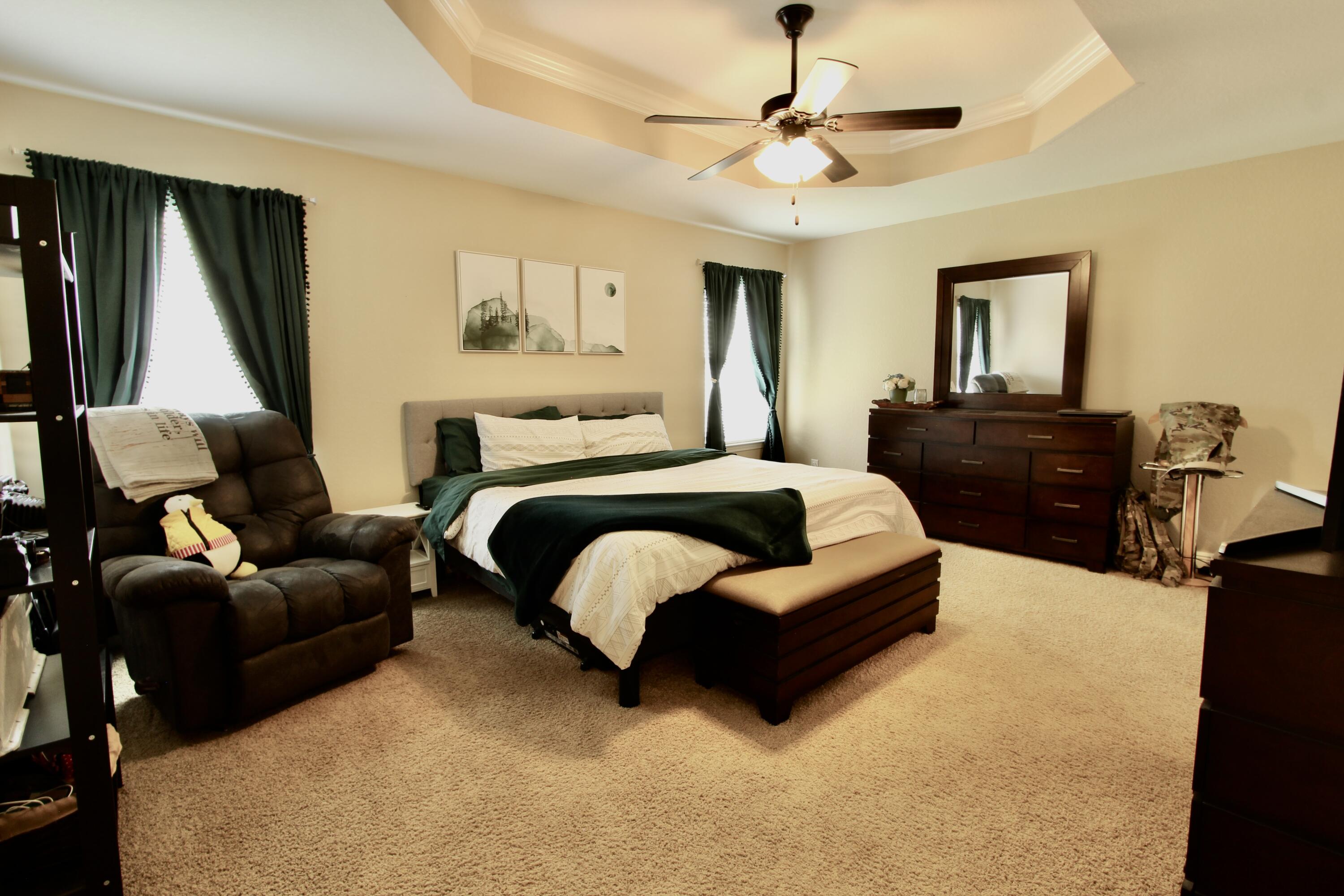 502 Vale Loop Crestview, FL 32536 - Photo 37 of 53 a bedroom with a bed couch chair and a window