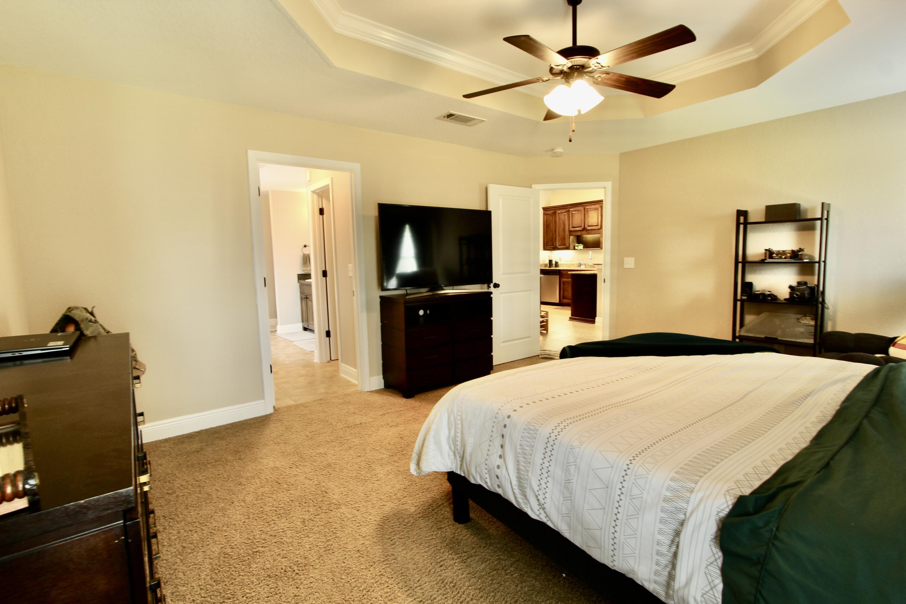 502 Vale Loop Crestview, FL 32536 - Photo 39 of 53 a bedroom with a bed and a flat screen tv