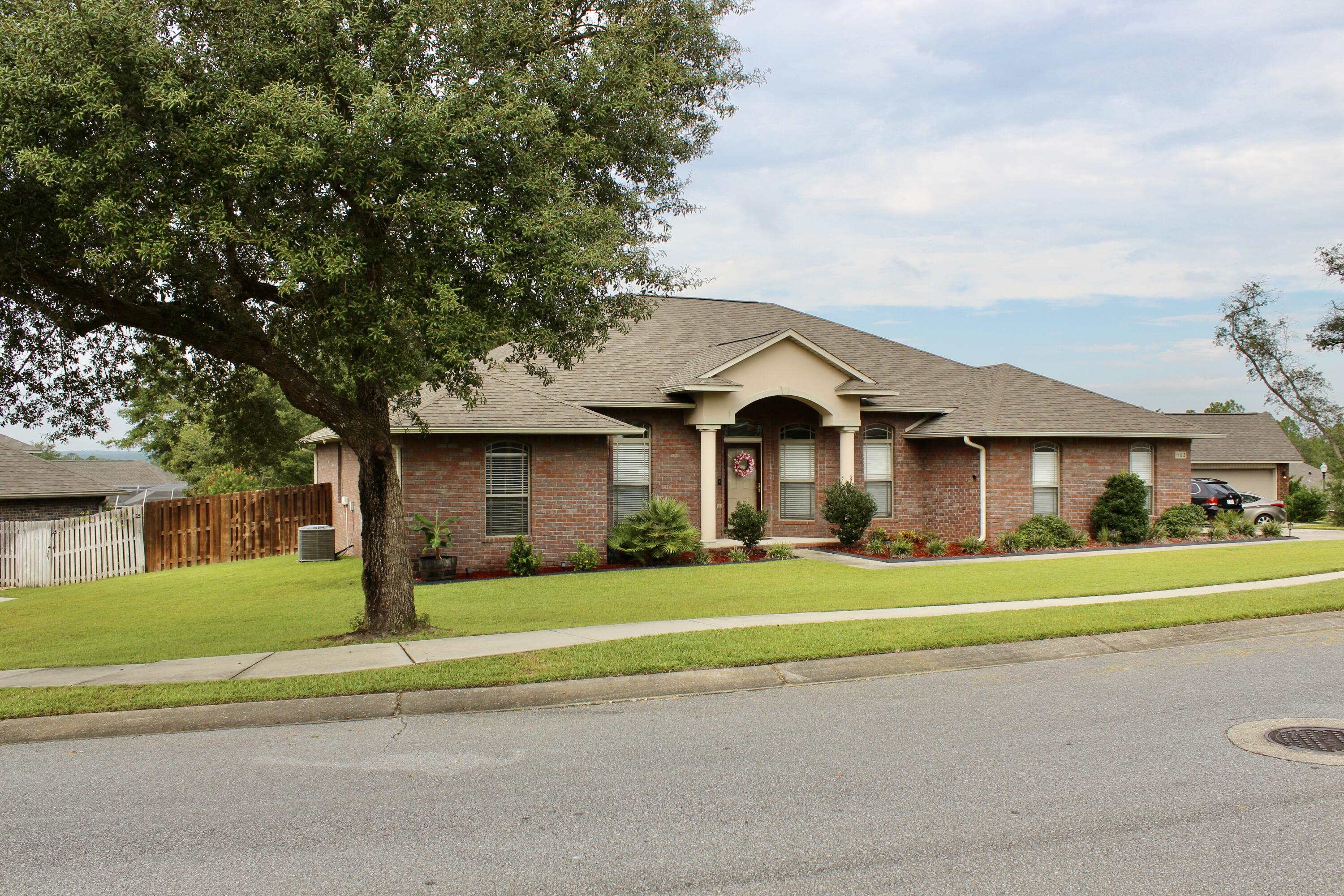 502 Vale Loop Crestview, FL 32536 - Photo 4 of 53 a front view of a house with a yard and trees