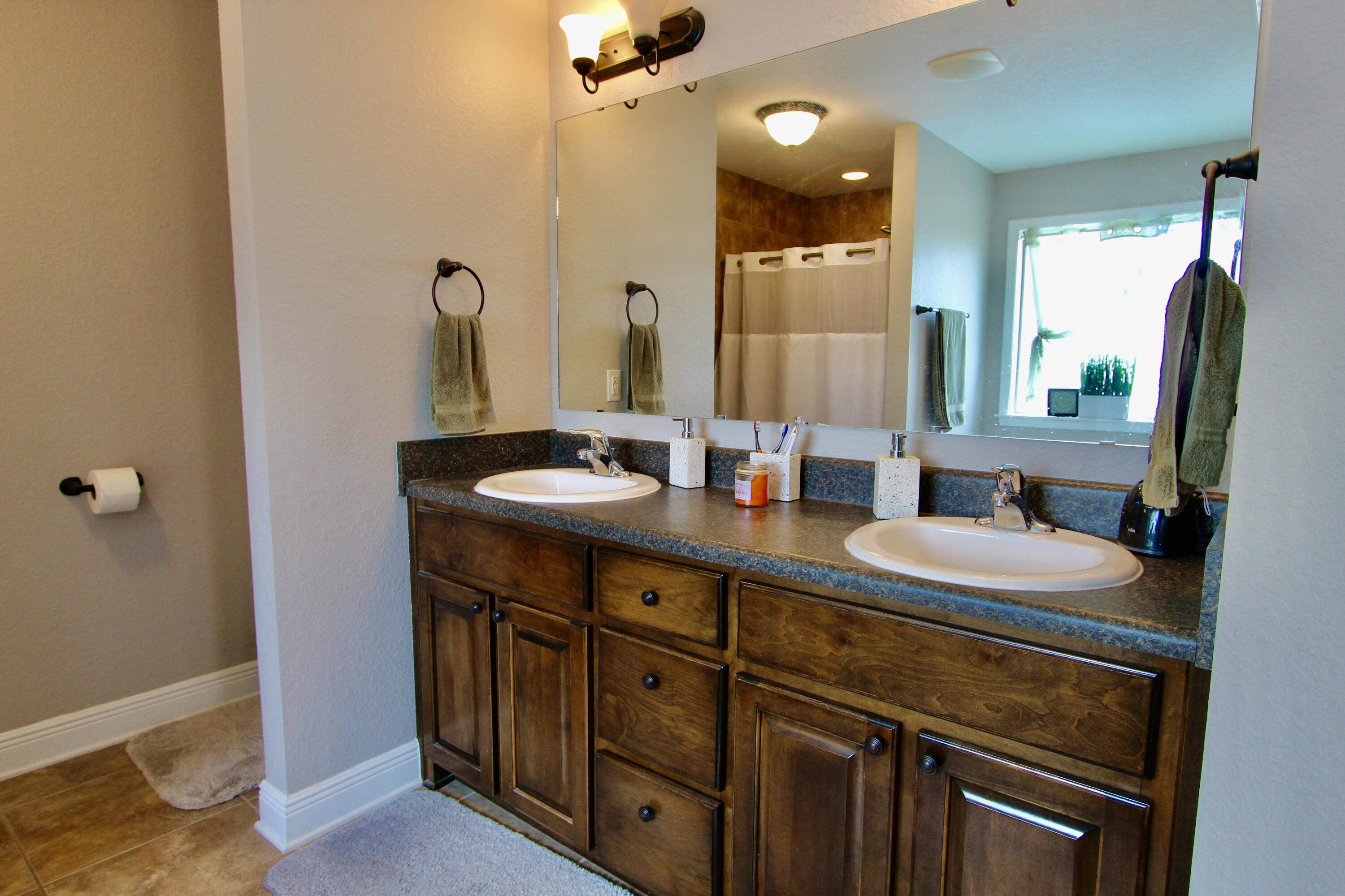 502 Vale Loop Crestview, FL 32536 - Photo 42 of 53 a bathroom with a double vanity sink and a mirror