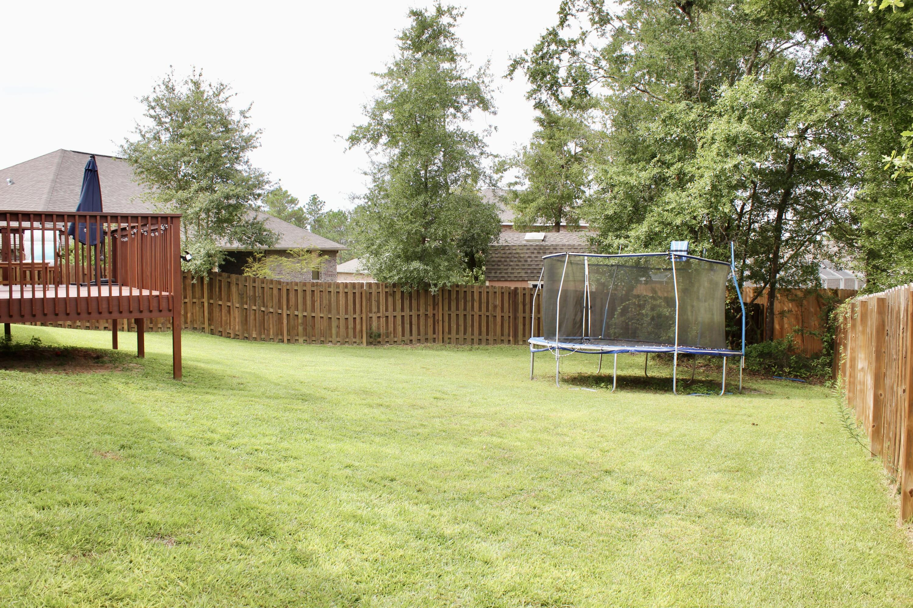 502 Vale Loop Crestview, FL 32536 - Photo 48 of 53 a view of a backyard with a slide and a bench