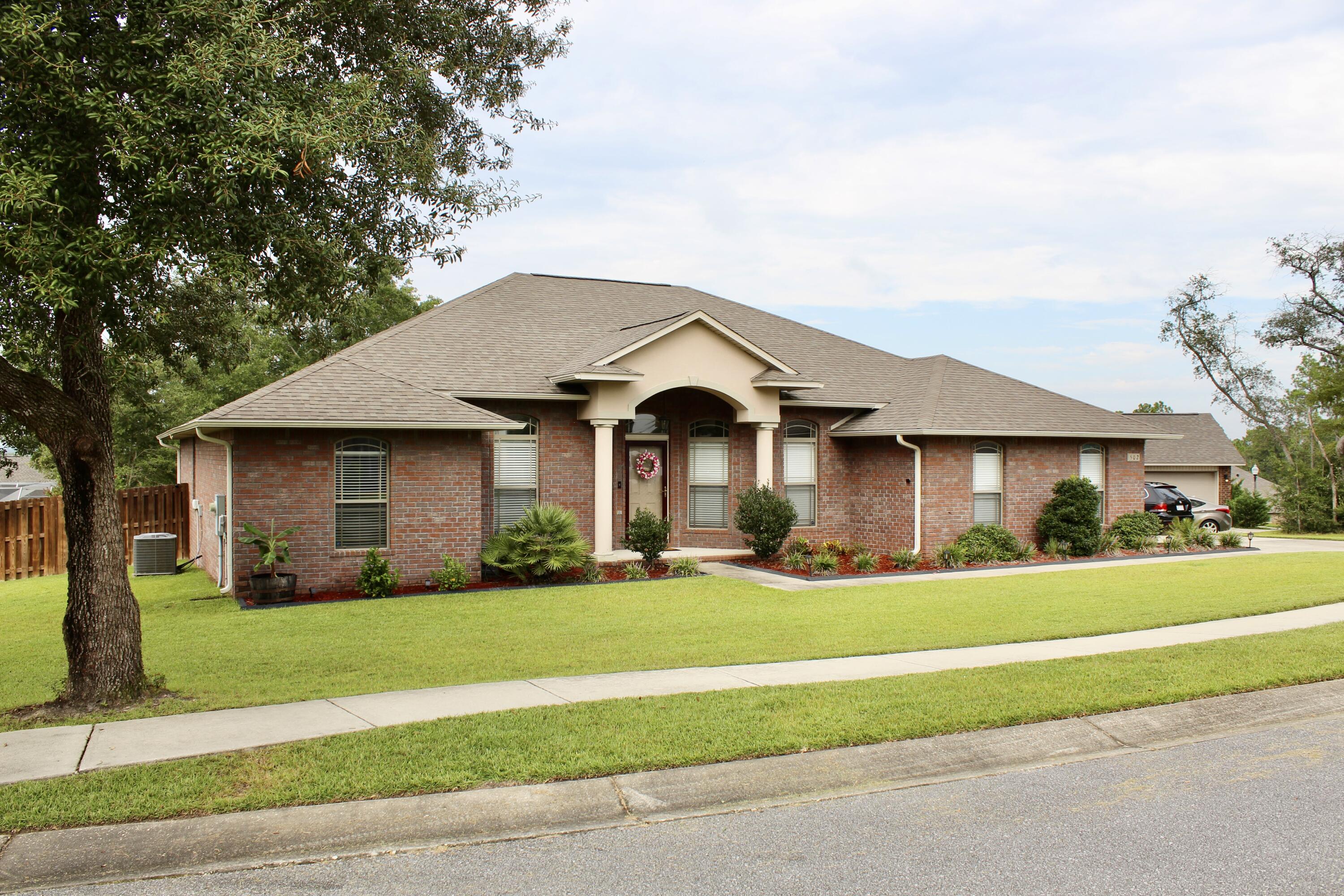 502 Vale Loop Crestview, FL 32536 - Photo 5 of 53 a front view of a house with a yard