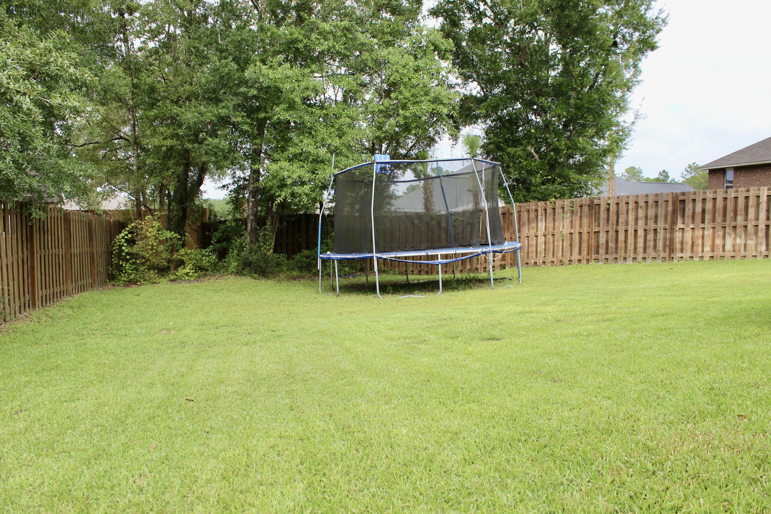 502 Vale Loop Crestview, FL 32536 - Photo 51 of 53 a wooden fence with some trees in the background