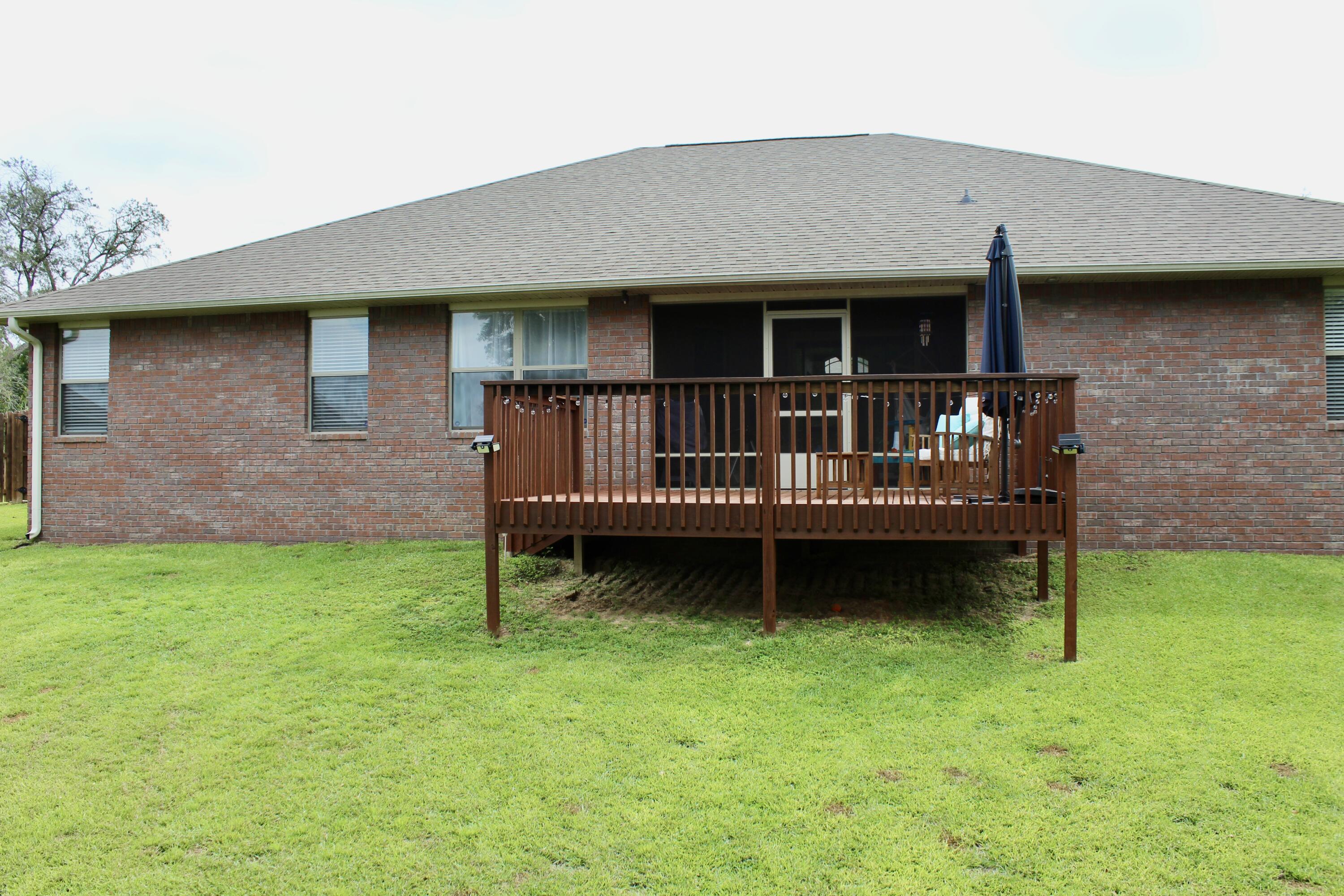 502 Vale Loop Crestview, FL 32536 - Photo 53 of 53 a view of a house with a wooden deck and a yard