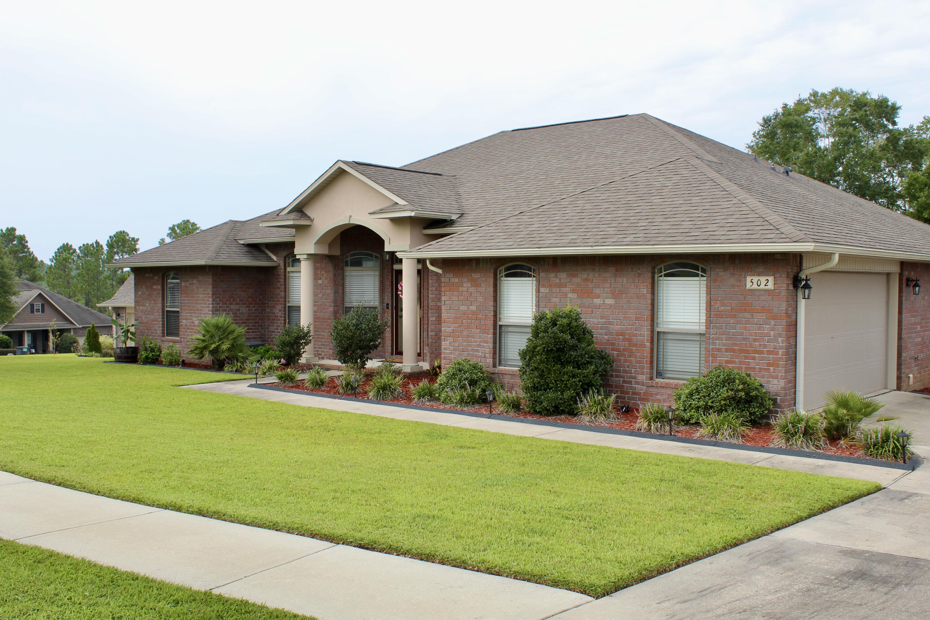 502 Vale Loop Crestview, FL 32536 - Photo 7 of 53 a front view of a house with a yard