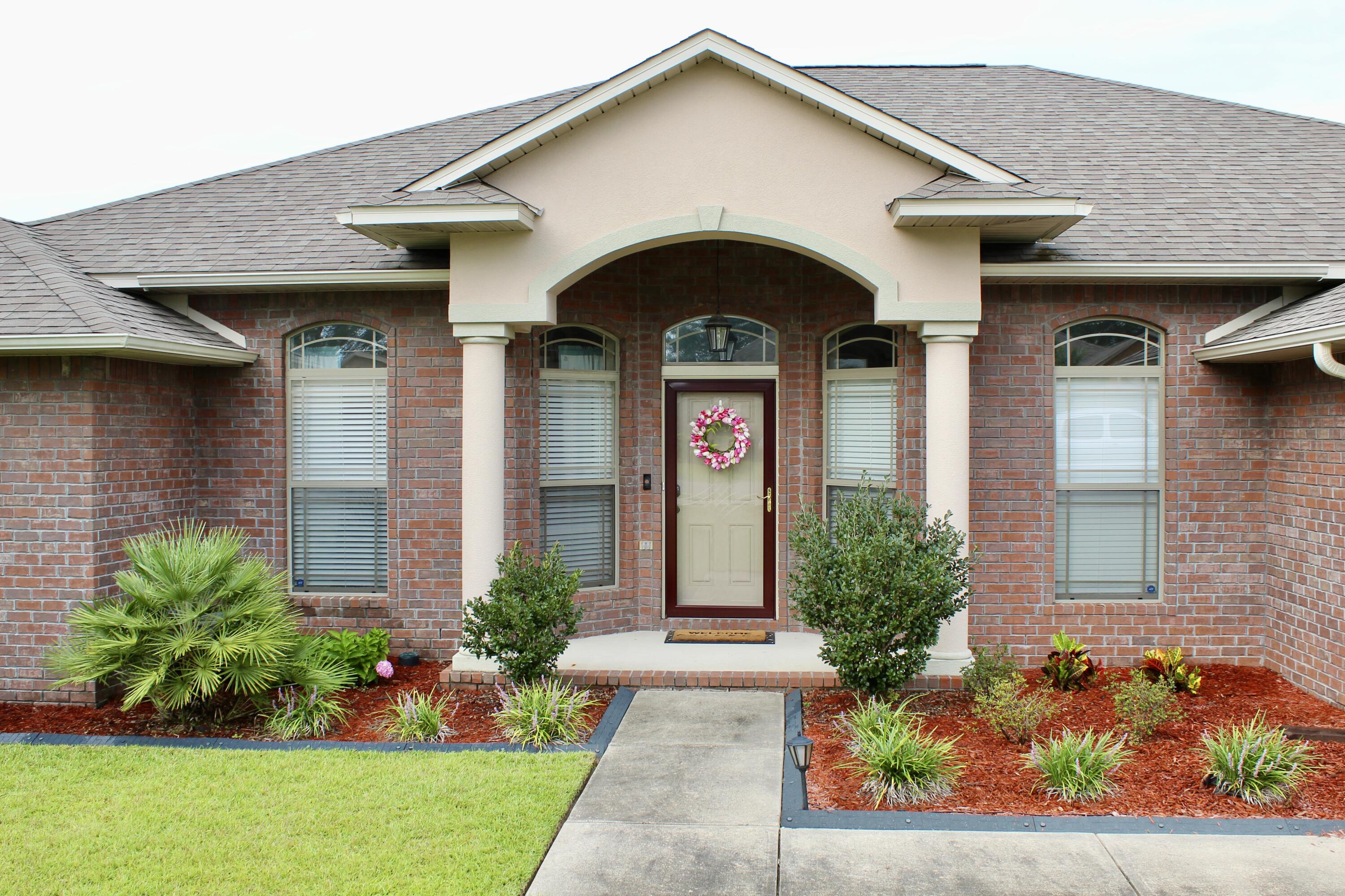 502 Vale Loop Crestview, FL 32536 - Photo 8 of 53 a front view of a house with a yard