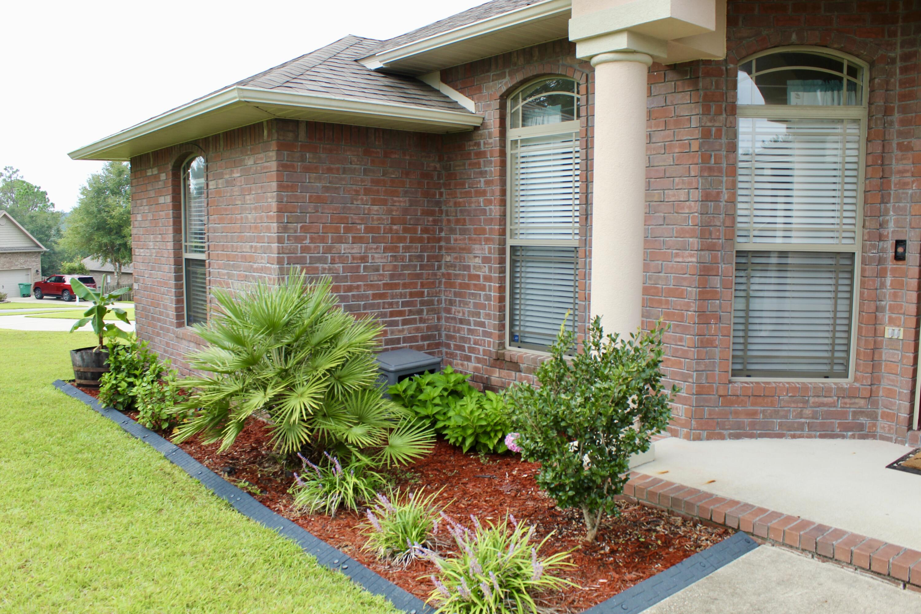 502 Vale Loop Crestview, FL 32536 - Photo 9 of 53 a front view of a house with a yard
