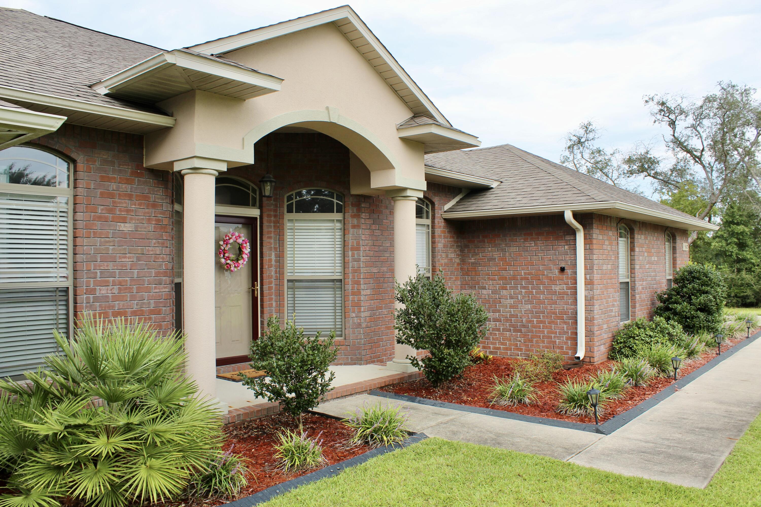 502 Vale Loop Crestview, FL 32536 - Photo 10 of 53 a front view of a house with a yard